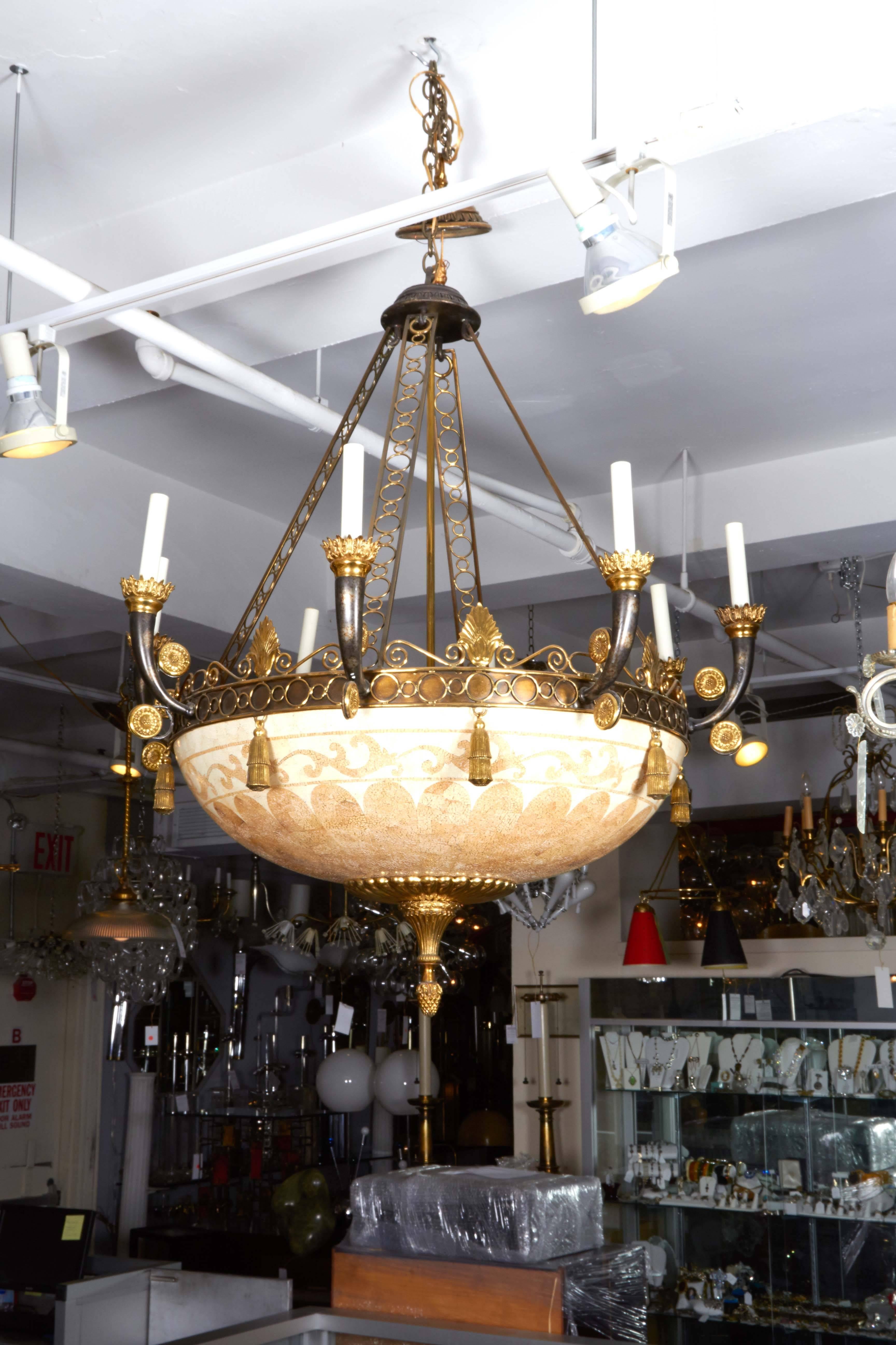 A vintage chandelier in the Empire style, including inverted shade with berry finial, designed with classically inspired mosaic in cast resin, accented with anthemions and s-scrolls to the rim, above ring border with hanging tassels, supporting