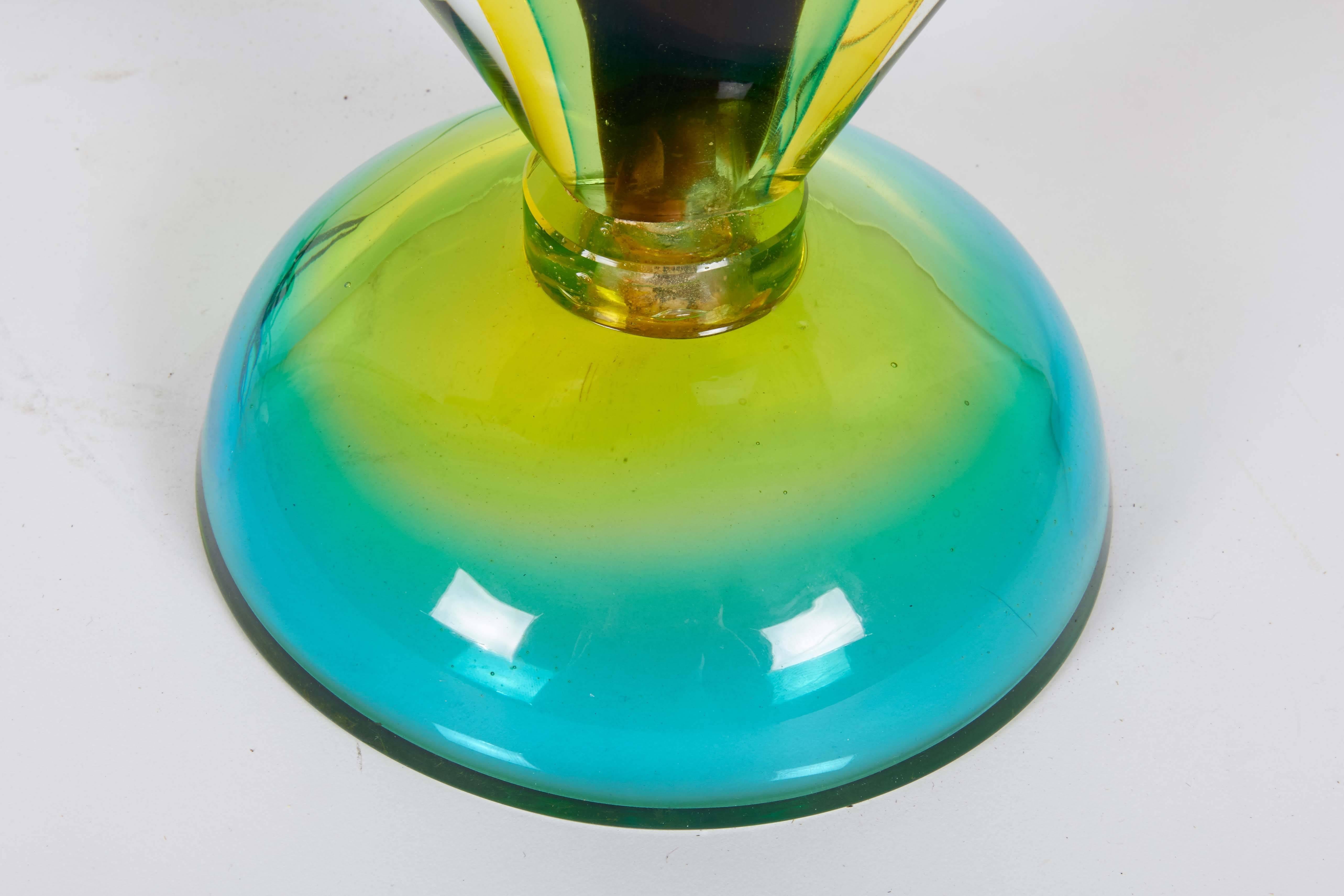 A vibrant Murano glass table lamp, manufactured circa, 1960s-1970s, with brass single socket mounted on body comprised of multicolored layers in brown, green, yellow and blue. Very good condition, wear consistent with age and use.

10423