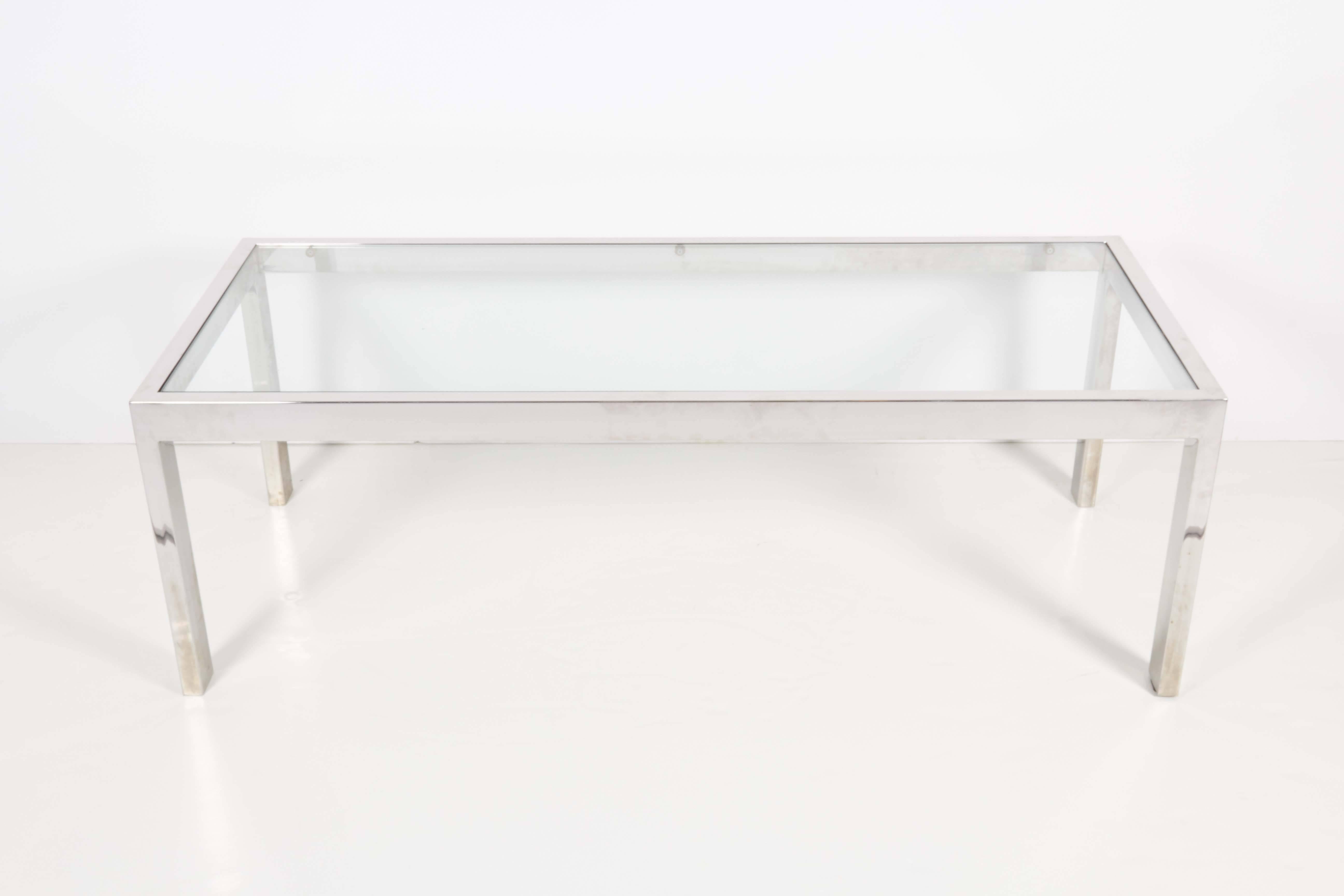 A modernist style coffee and cocktail table, produced circa 1970s, with rectilinear chrome frame and glass top inset. Very good vintage condition, wear to metal consistent with age and use.

10362