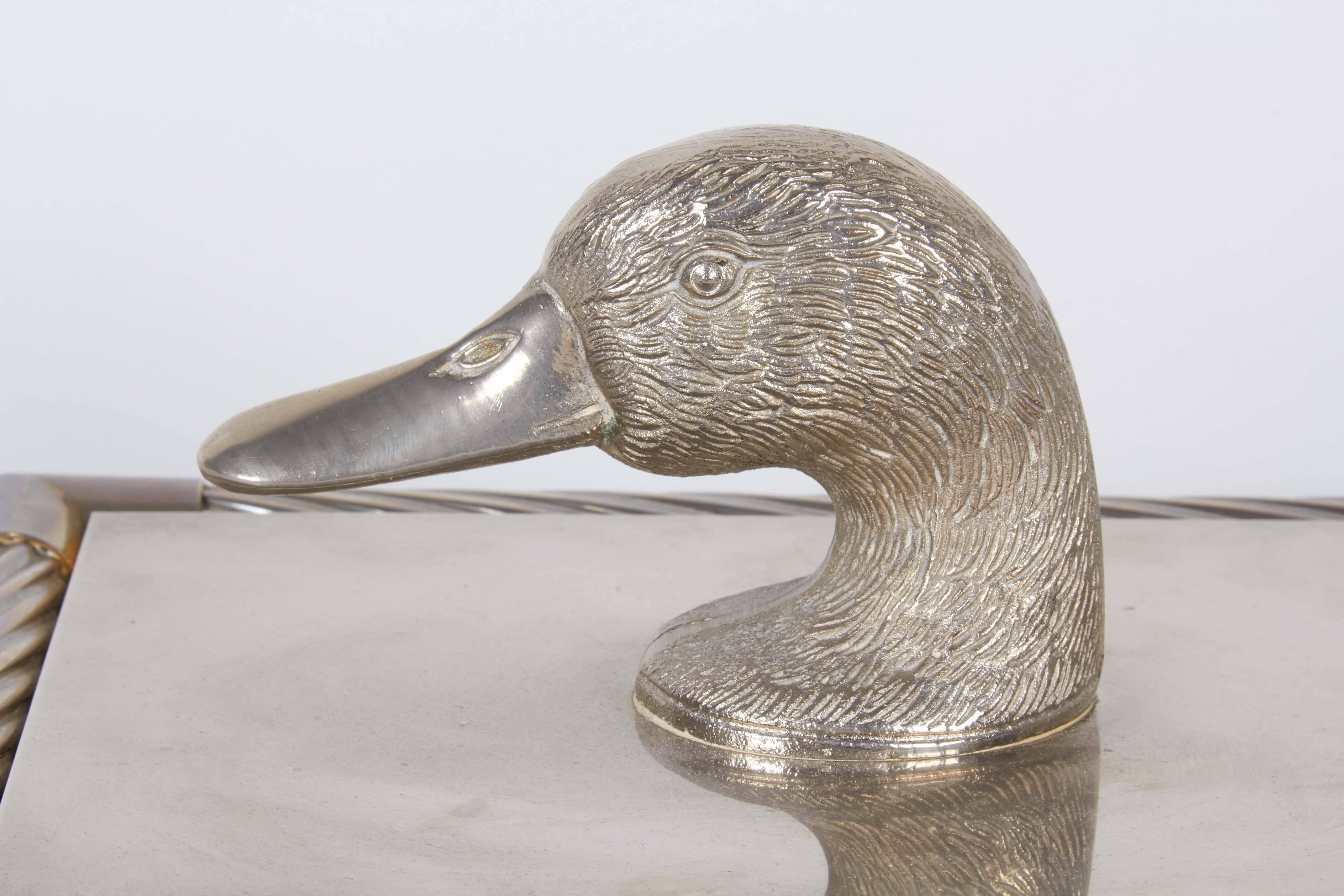 A vintage decorative box in metal against wood base, featuring a duck head finial as lid handle, on box with twisted reed frame, with brown felt interior. Good overall condition, with age appropriate wear.