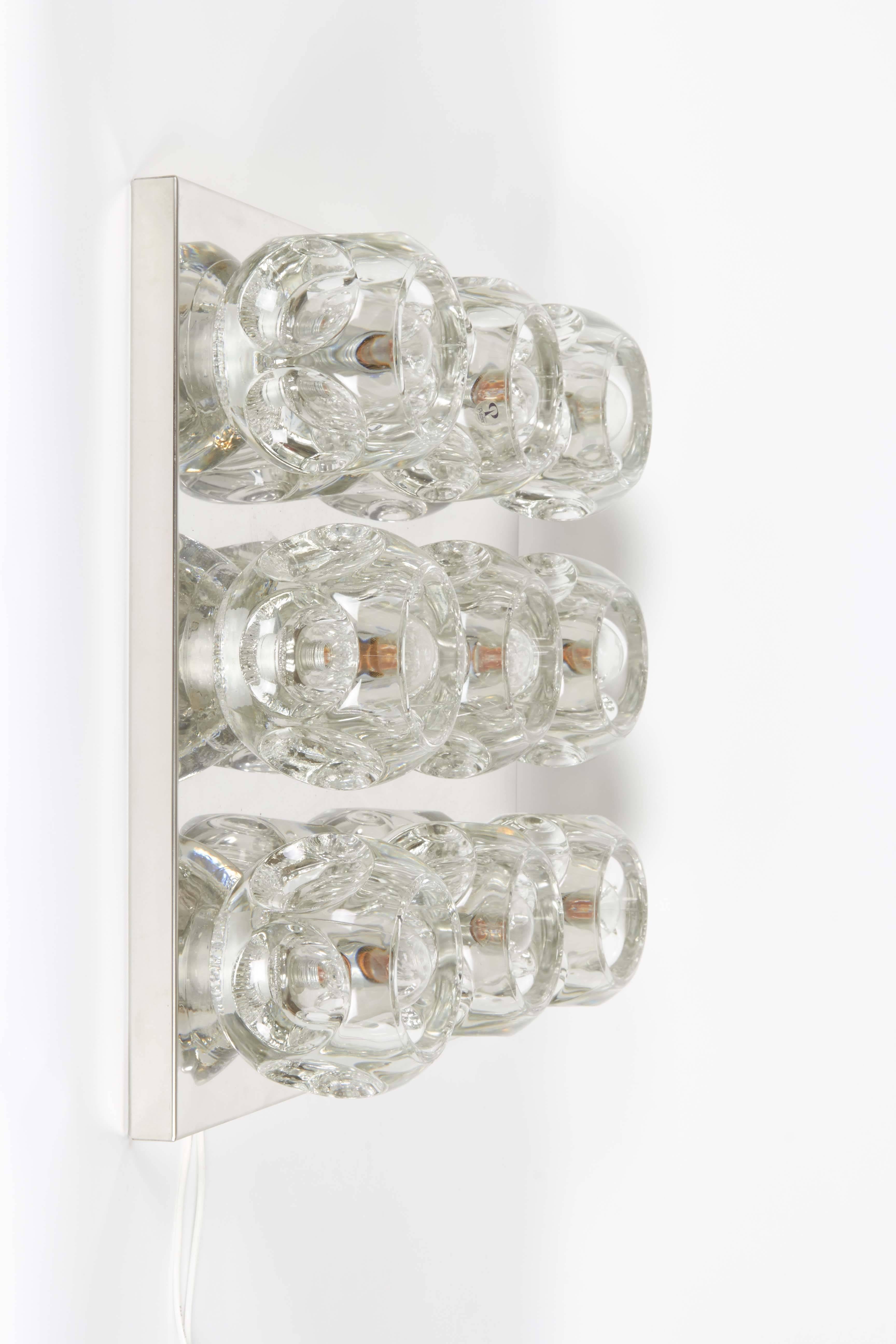 A circa 1970s large ceiling or wall light fixture, manufactured by Peill and Putzler of Germany, with nine heavy, faceted crystal glass cubes as socket covers, mounted to a square, polished chrome body. Sockets to US standard, requires E14 (130