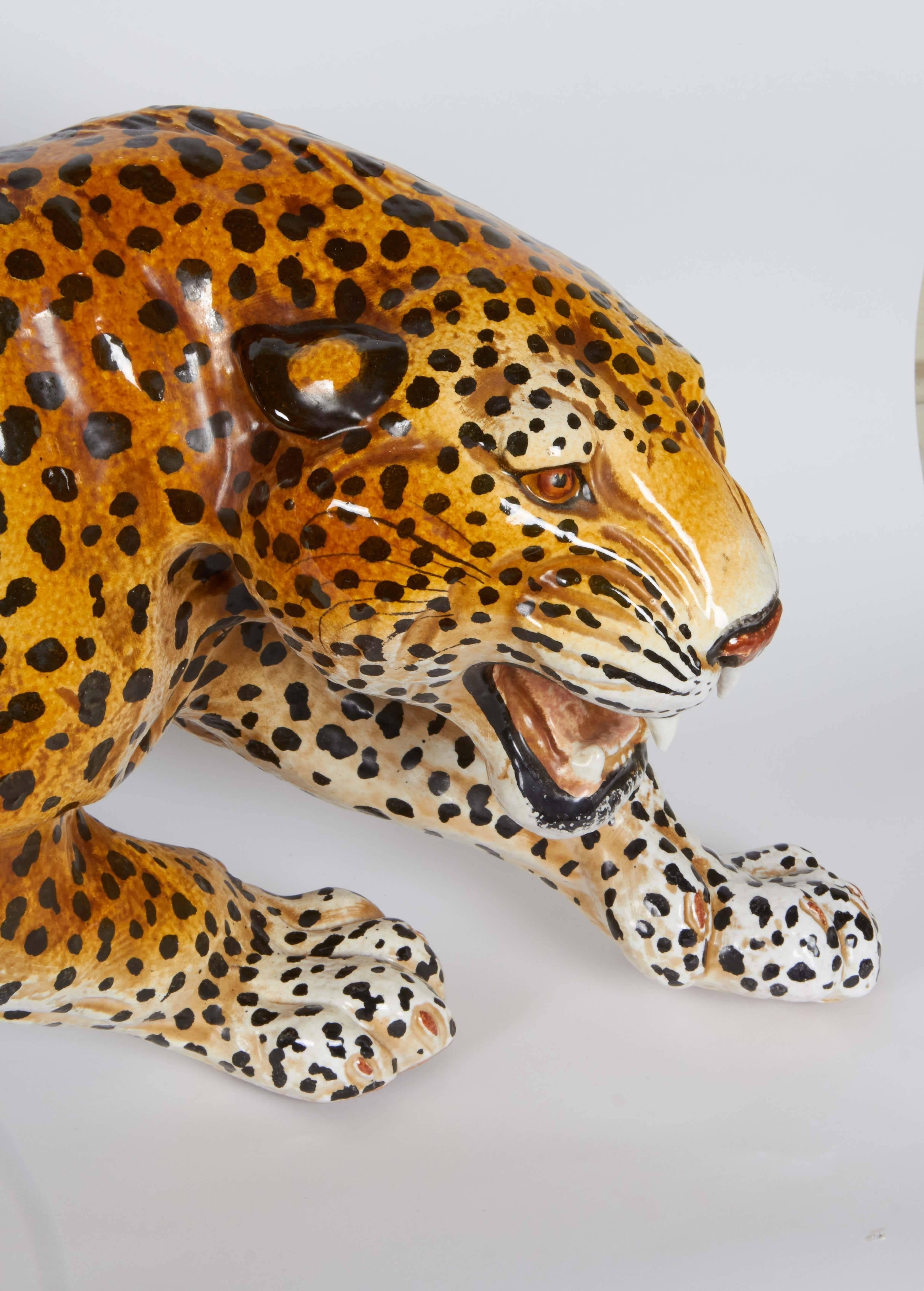 A vintage sculpture of a leopard, produced in Italy, hand-painted in glazed terracotta. Markings include several stamps [Made in Italy] to the feet. Despite slight chip to one tooth, this sculpture remains in a very good condition.