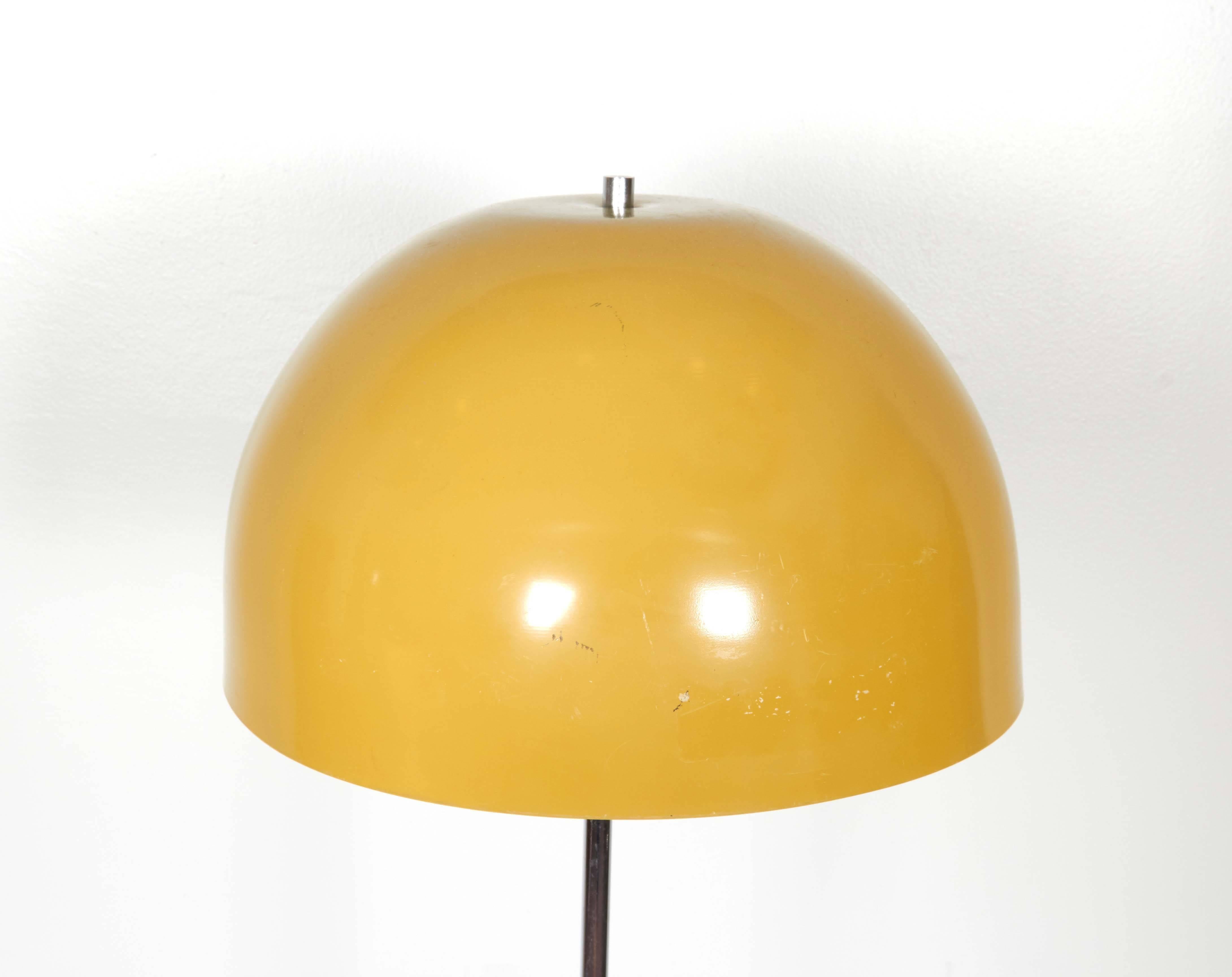 This circa 1960s floor lamp includes dome form shade in yellow enamel, surrounding two ceramic sockets, on metal stem and circular base. Requires two medium base bulbs. The lamp remains in good vintage condition, with age appropriate wear.

10384