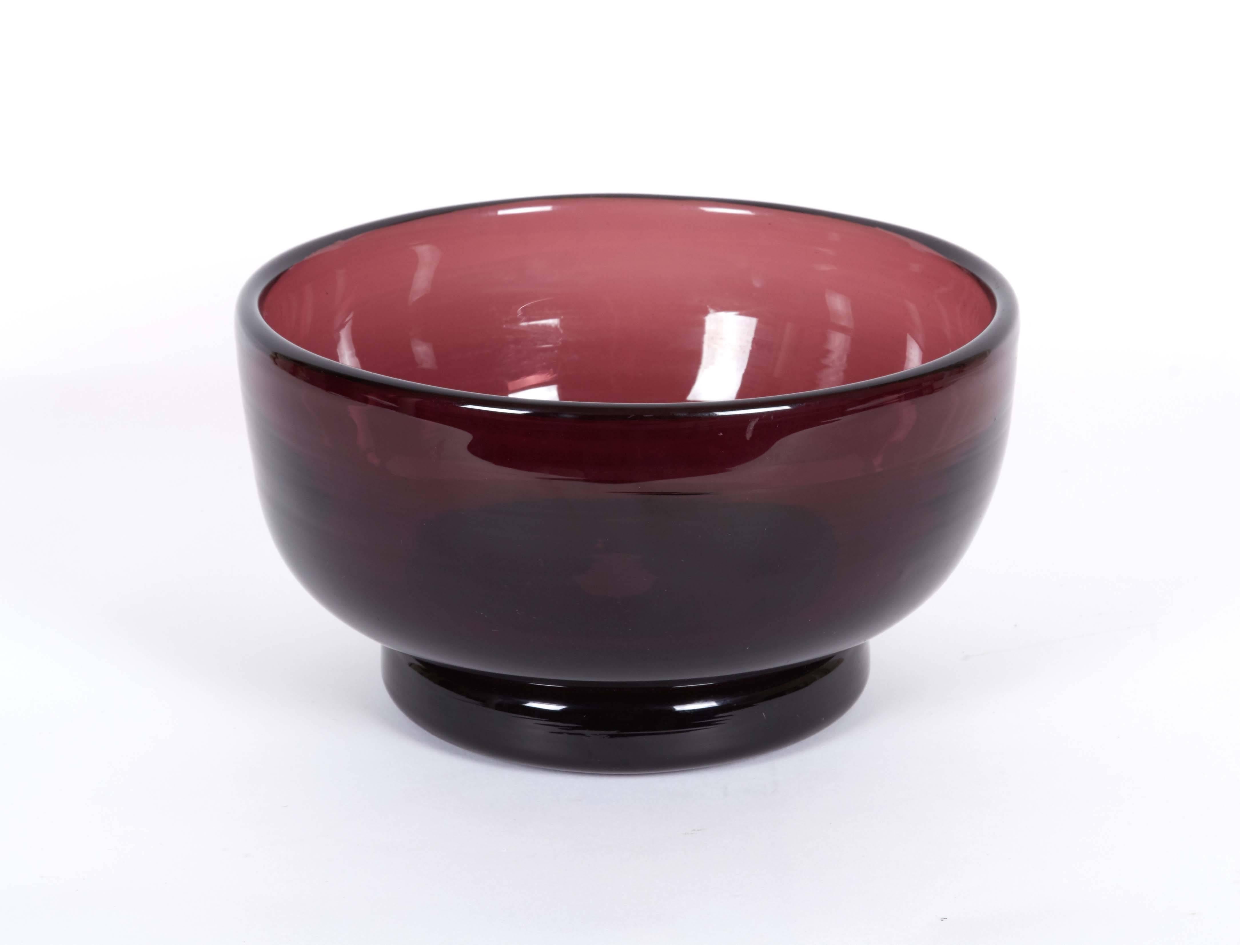 A footed bowl, entirely in heavy hand blown aubergine glass, circa 1960s. Very good vintage condition, minor presence of naturally occurring bubbles, wear to base consistent with age and use.