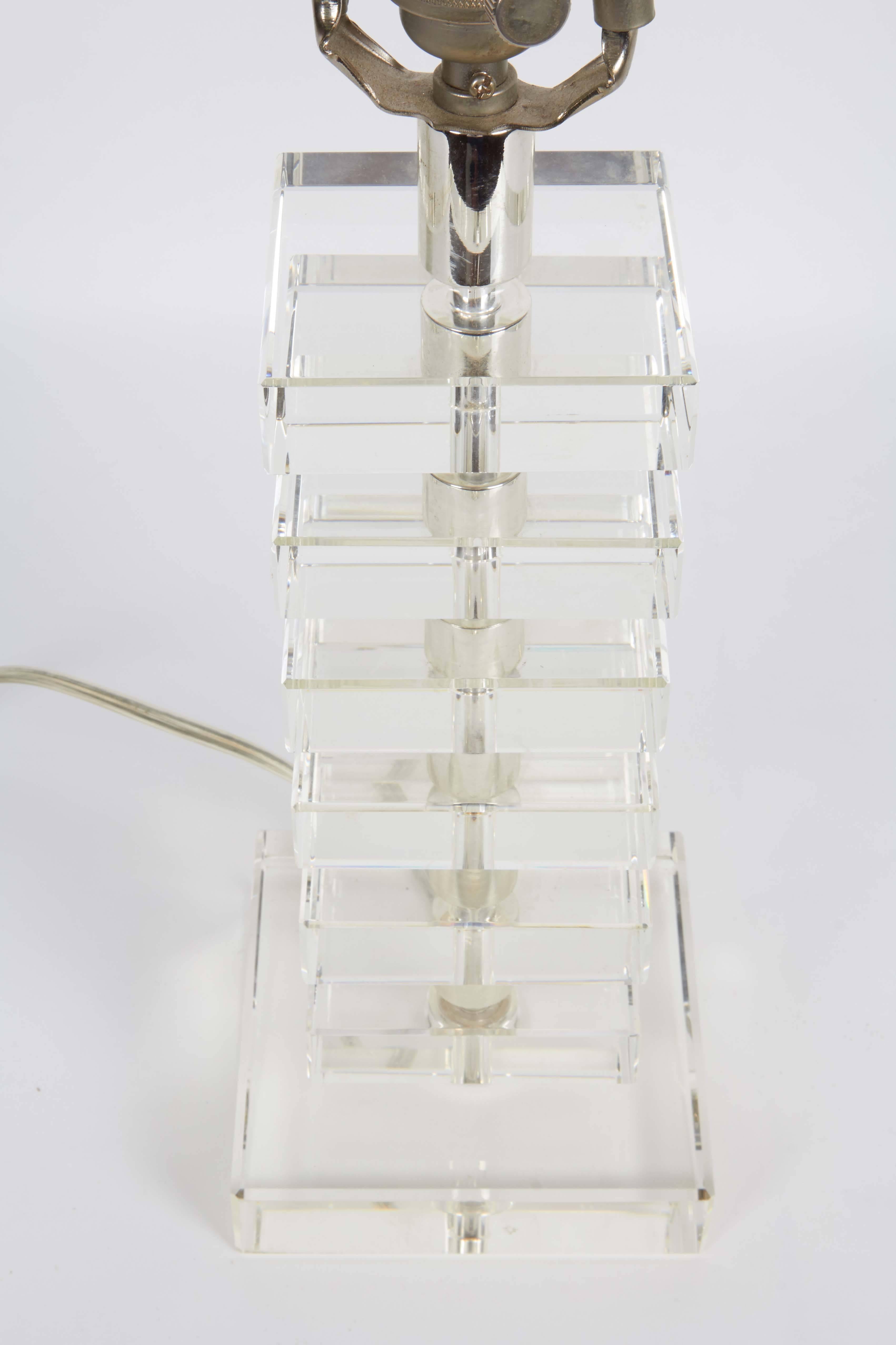 A modernist style table lamp by Robert Abbey with original cube form finial and single socket on body comprised of stacked glass blocks. Markings include [Robert Abbey] stamped to socket. Very good condition, wear consistent with age and use.