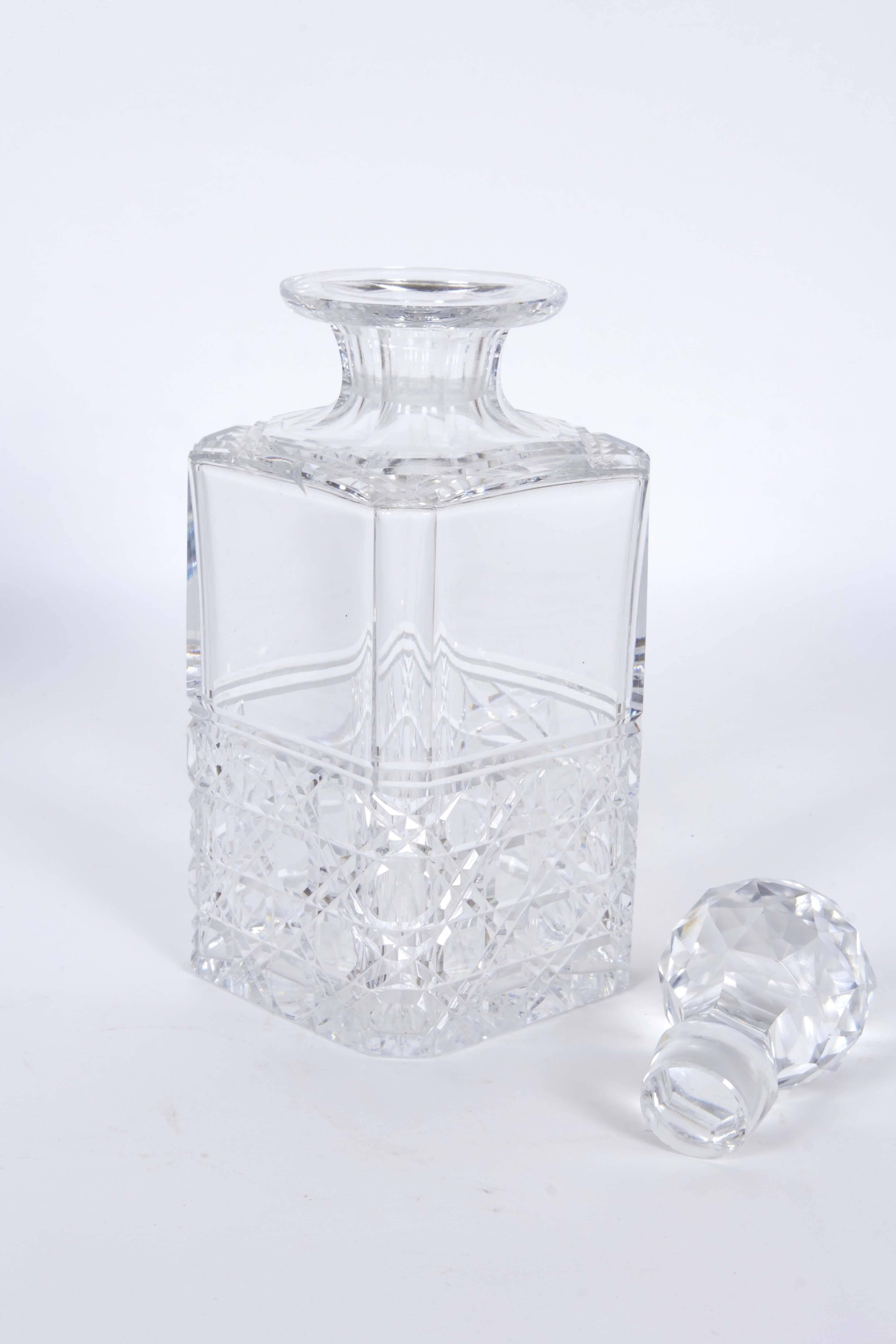 A set of three Edinburgh crystal decanters, produced within the early 20th century period, circa 1900s to 1930, each with original faceted stopper, on cut glass square bottle. Markings include [Made in Edinburgh Scotland] signed to the bottom