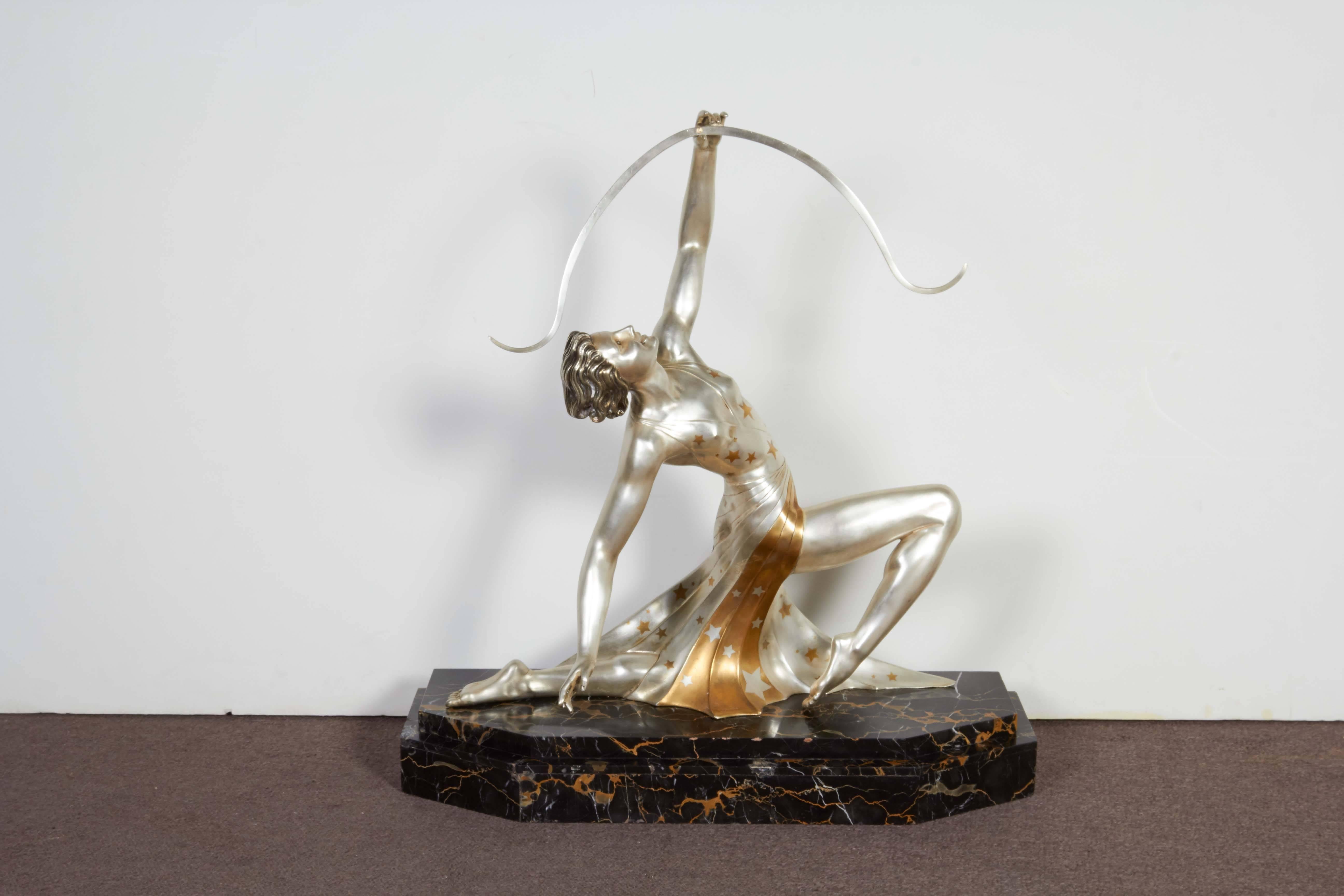 Very large and important French Art Deco sculpture of a female figure in typical 1920s garb. Nickeled bronze with intricate parcel gilt star pattern overall, resting on original stepped black and gold, portoro marble base.
 Signed: G. Daverny -