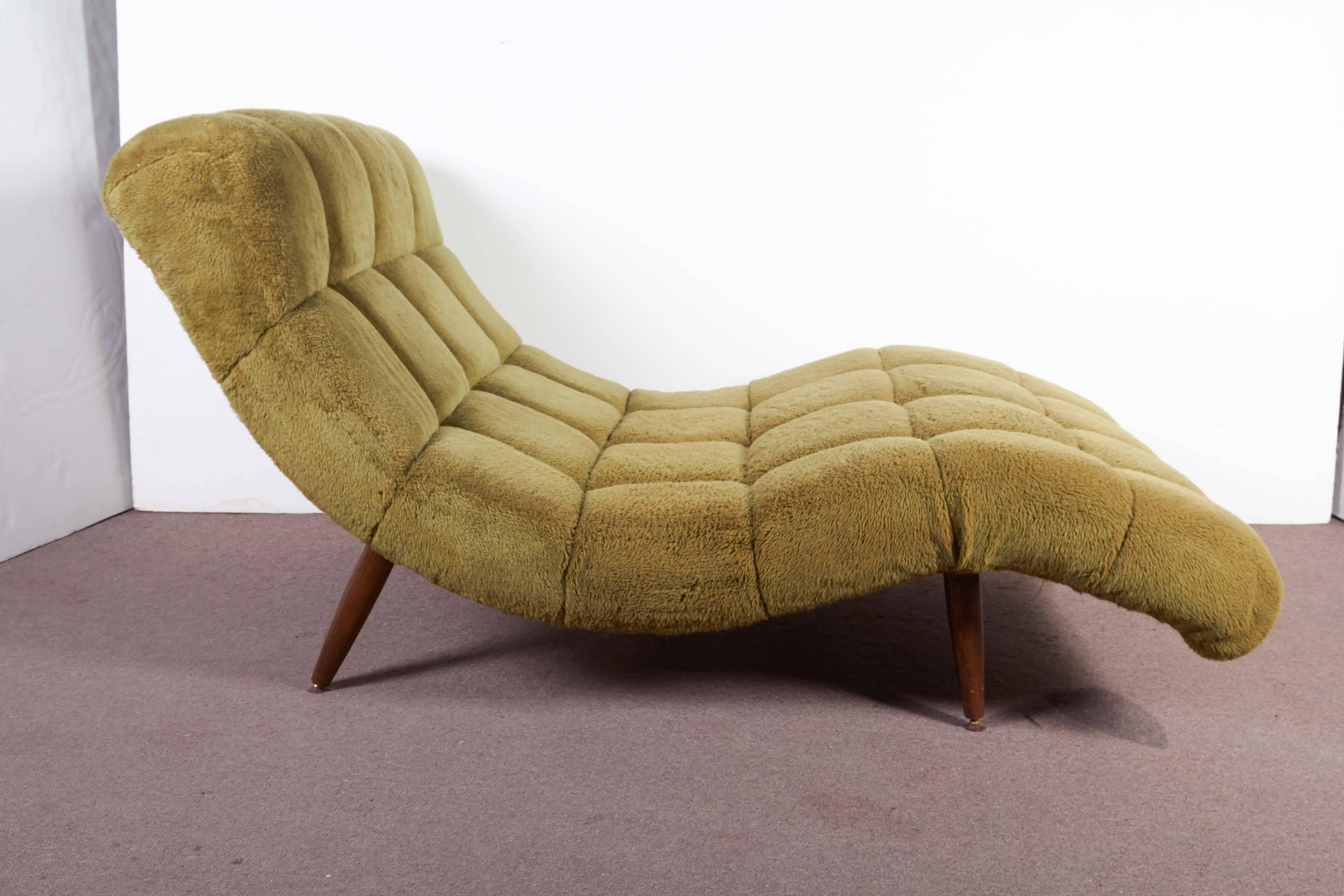 A modernist, wave design couples loveseat or recamier in the style of Adrian Pearsall in pistachio colored faux fur with a very comfortably designed seating area that can seat one or two.
The upholstery is in original condition with its cushioned,