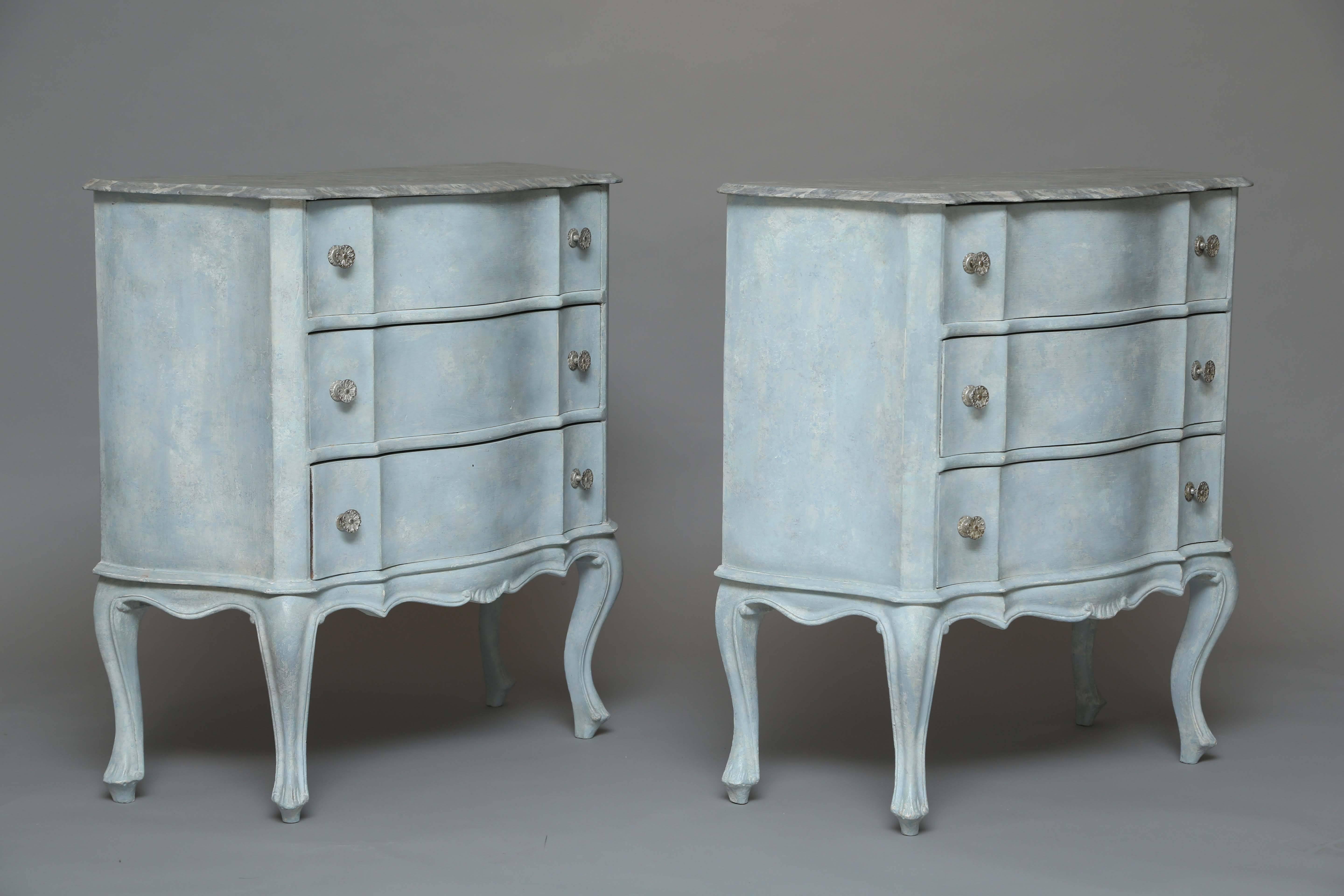 Pair of chests, with painted finish; each having a molded and shaped faux-marble top, on conforming base of three stacked drawers, over serpentine apron centered with combing, raised on cabriole legs and toupie feet.