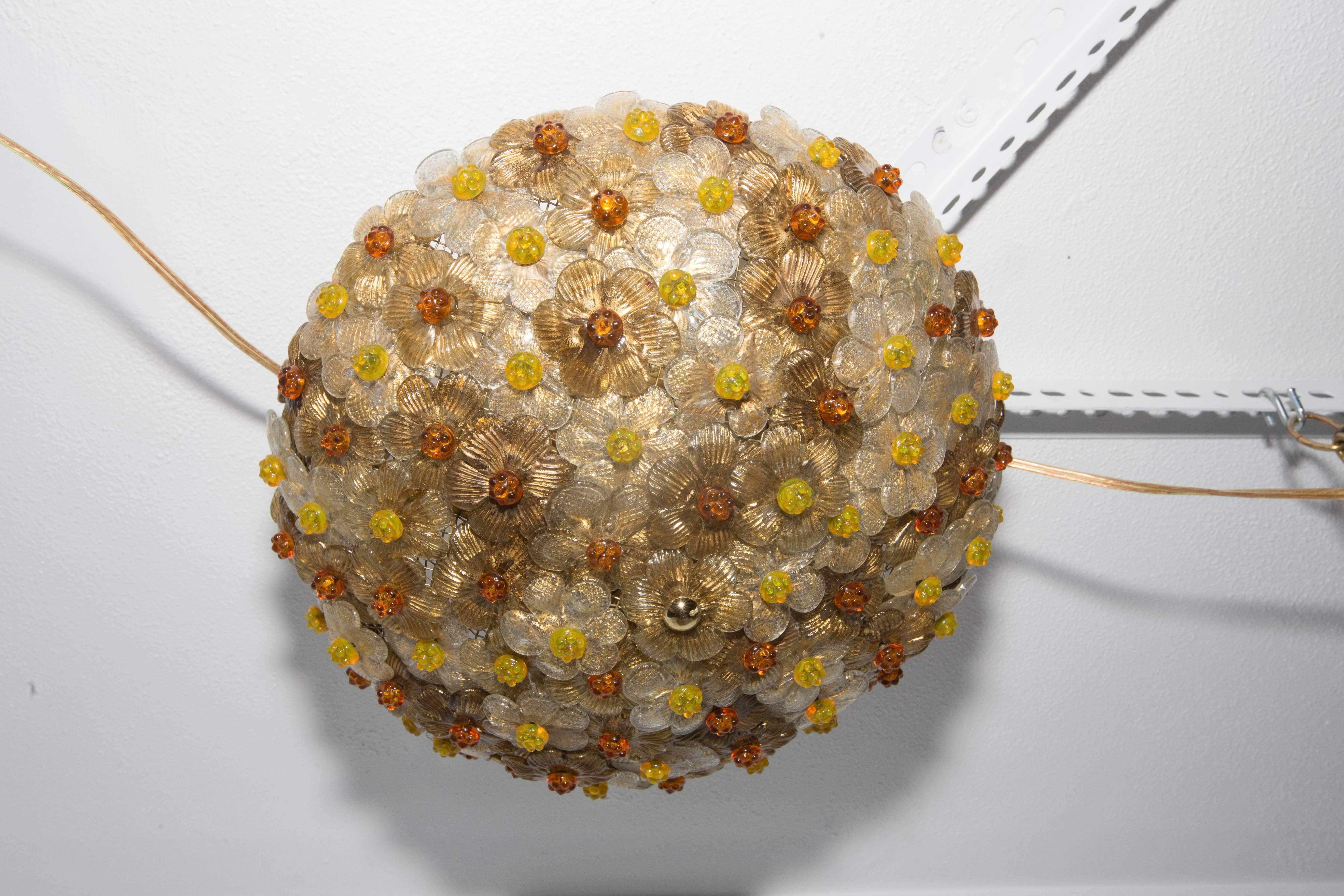Dome form flush mount composed of multiple amber and golden glass flowers with rosette details.