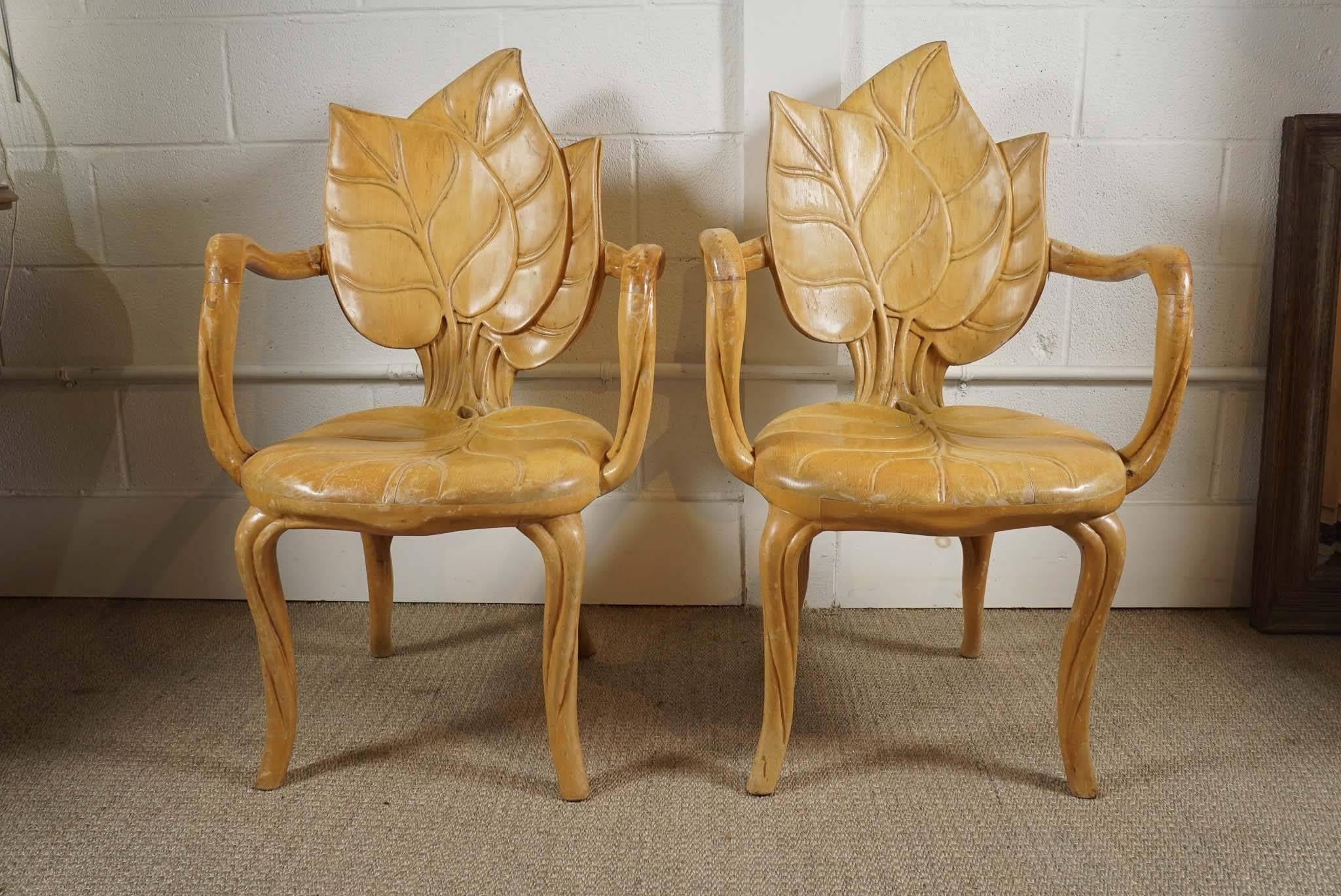 Here is a pair of beautiful carved wood leaf armchairs in a blonde oak finish.
  