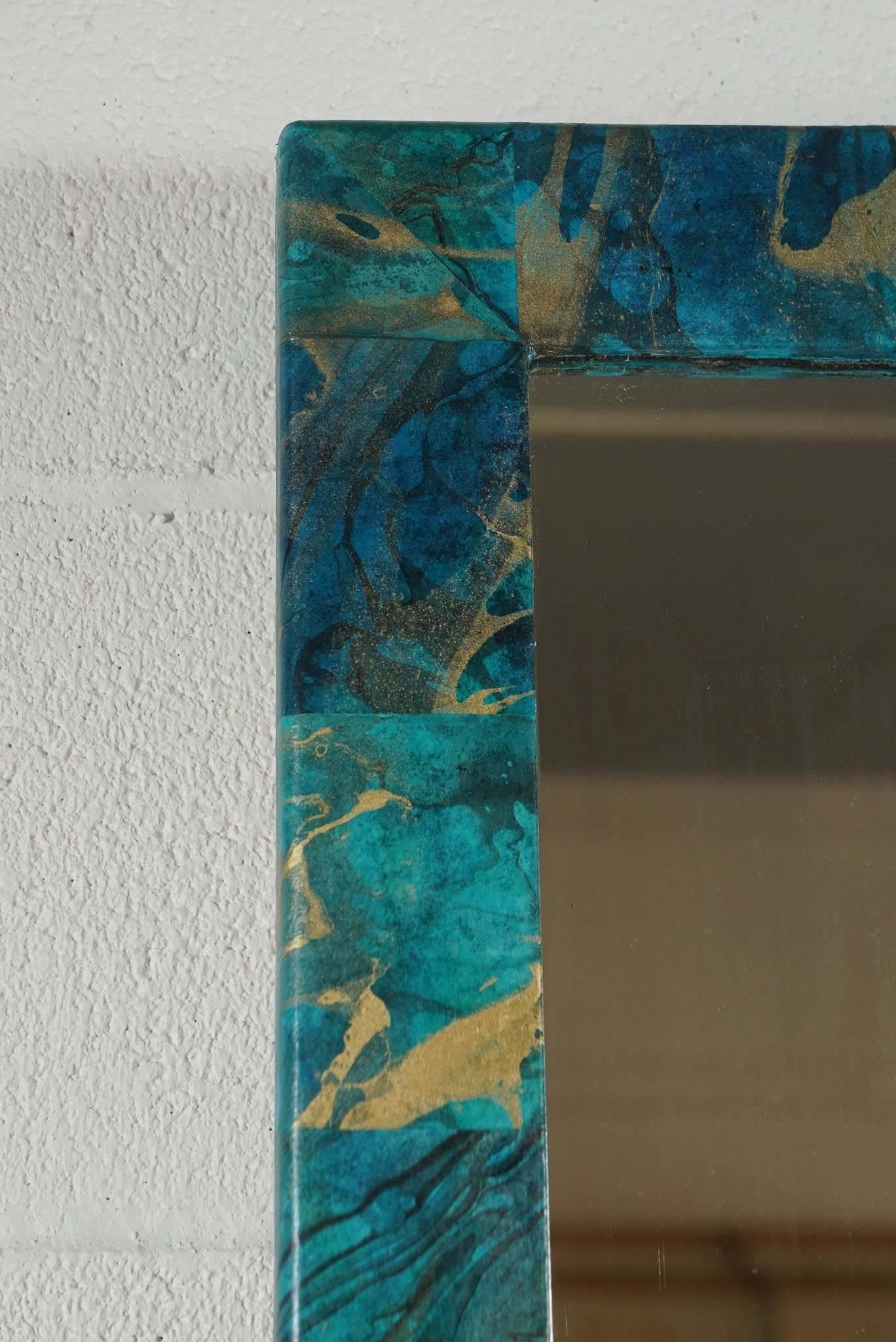 Here is a beautiful solid wood mirror that has been decoupaged in a block pattern with a marbleized turquoise and gold paper. The surface has been treated with a double coat satin medium. The mirror insert has a desirable vintage surface with slight