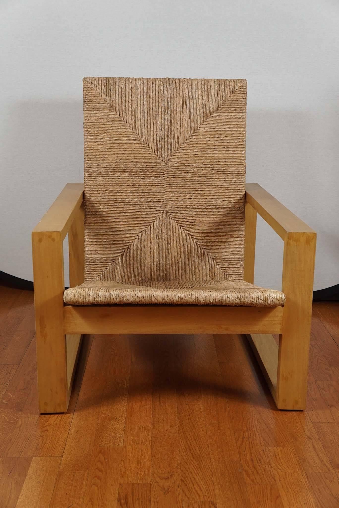 Modern square armchair, shown in blonde primavera wood with a natural rush seat and back. Also available in ebonized Rosa Marada wood, with an ebonized rattan seat.
Seat and back cushion available. COM-two yards.