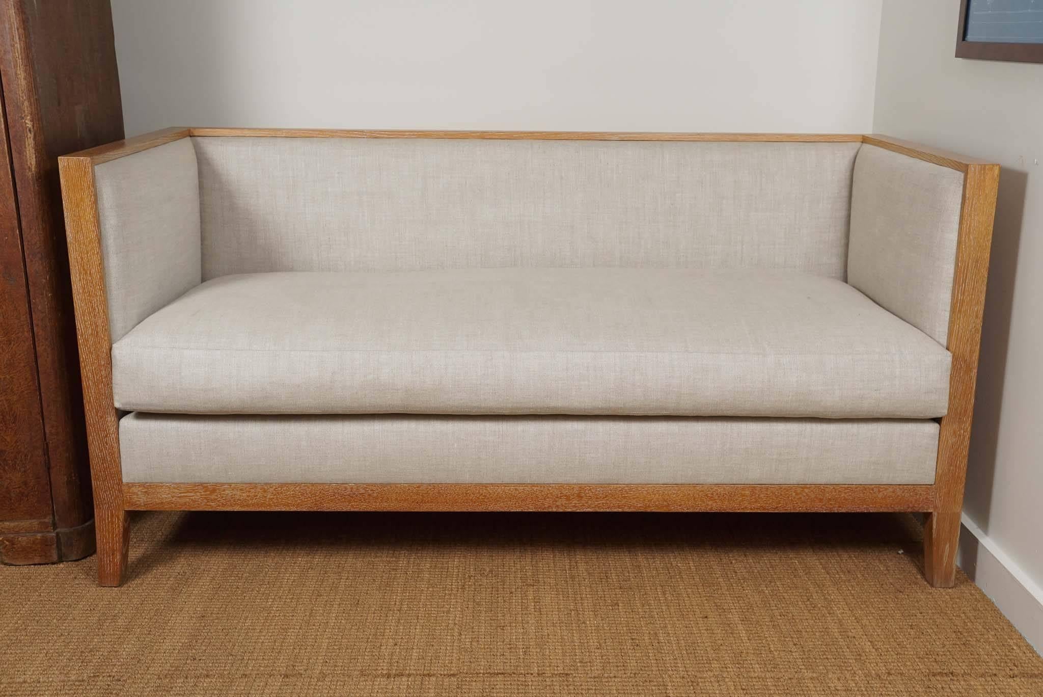 French style settee, interpreted from a Classic Jean-Michel Frank design.
Tight back and sides on interior with loose seat cushion.
Shown in light cerused oak and natural linen.

Custom finishes available: Light cerused oak, ebonized mahogany,