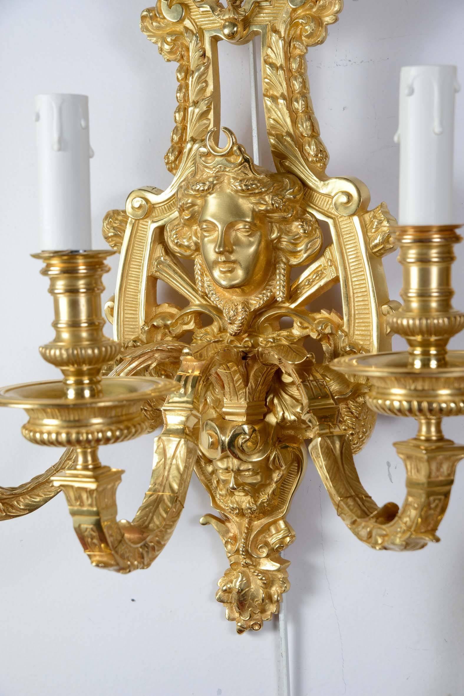 Two gilt bronze sconces in the French Régence style.
Three arms of lights each.
 