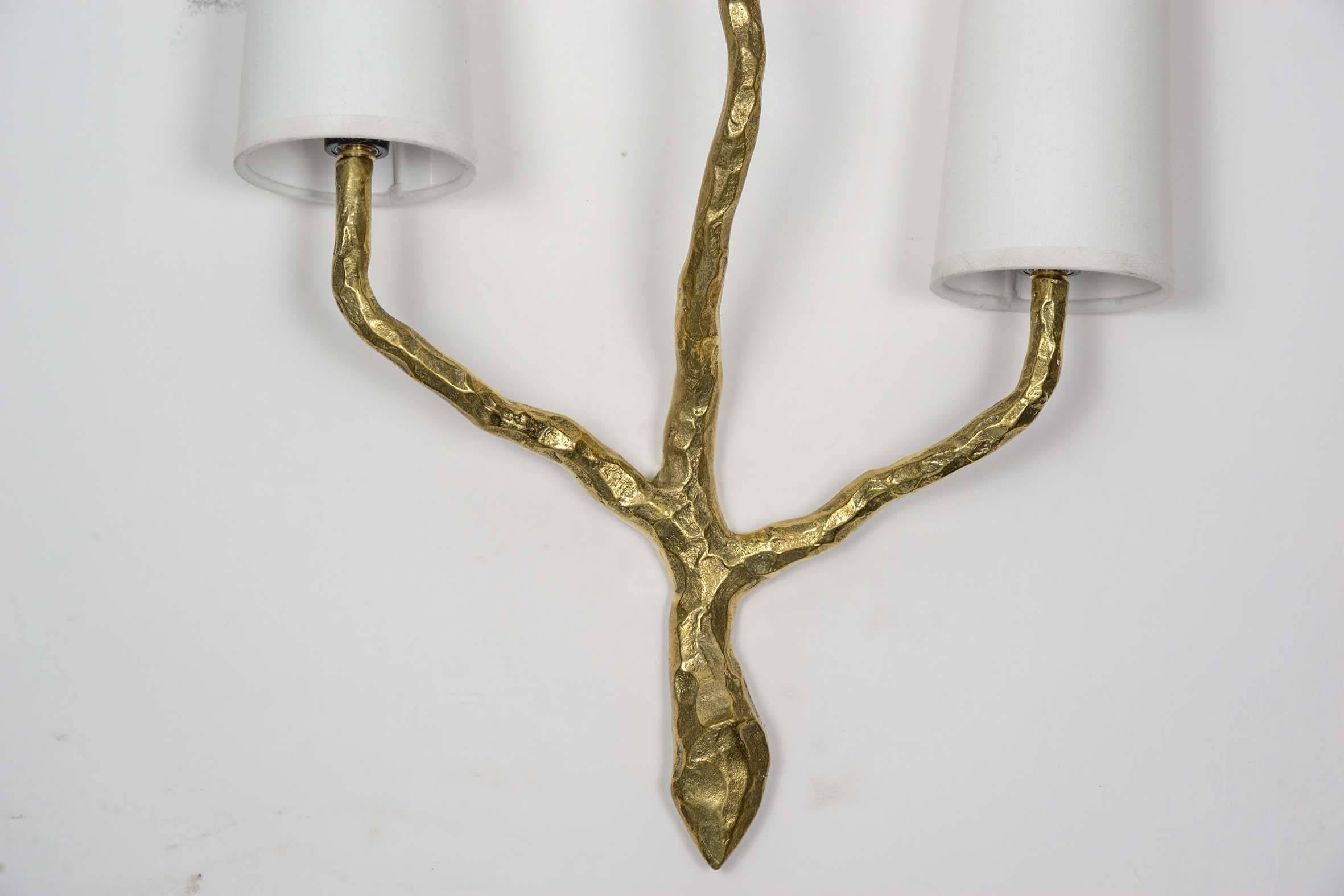 Rare set of four wall sconces, made by Maison Arlus in the 1960s in the manner of Felix Agostini.

Three arms of light in hammered and gilded bronze in the pure Brutalist way.
