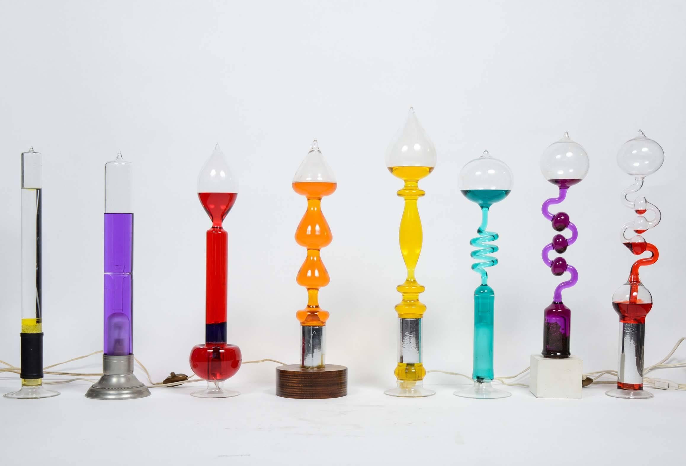 Unique collection of 14 glass lamps of different shapes and sizes with a test tube, chemical aspect, with colored liquid inside.

The bulb inside the lamp is heating the liquid in the lamps which will start to bubble and circulate inside the