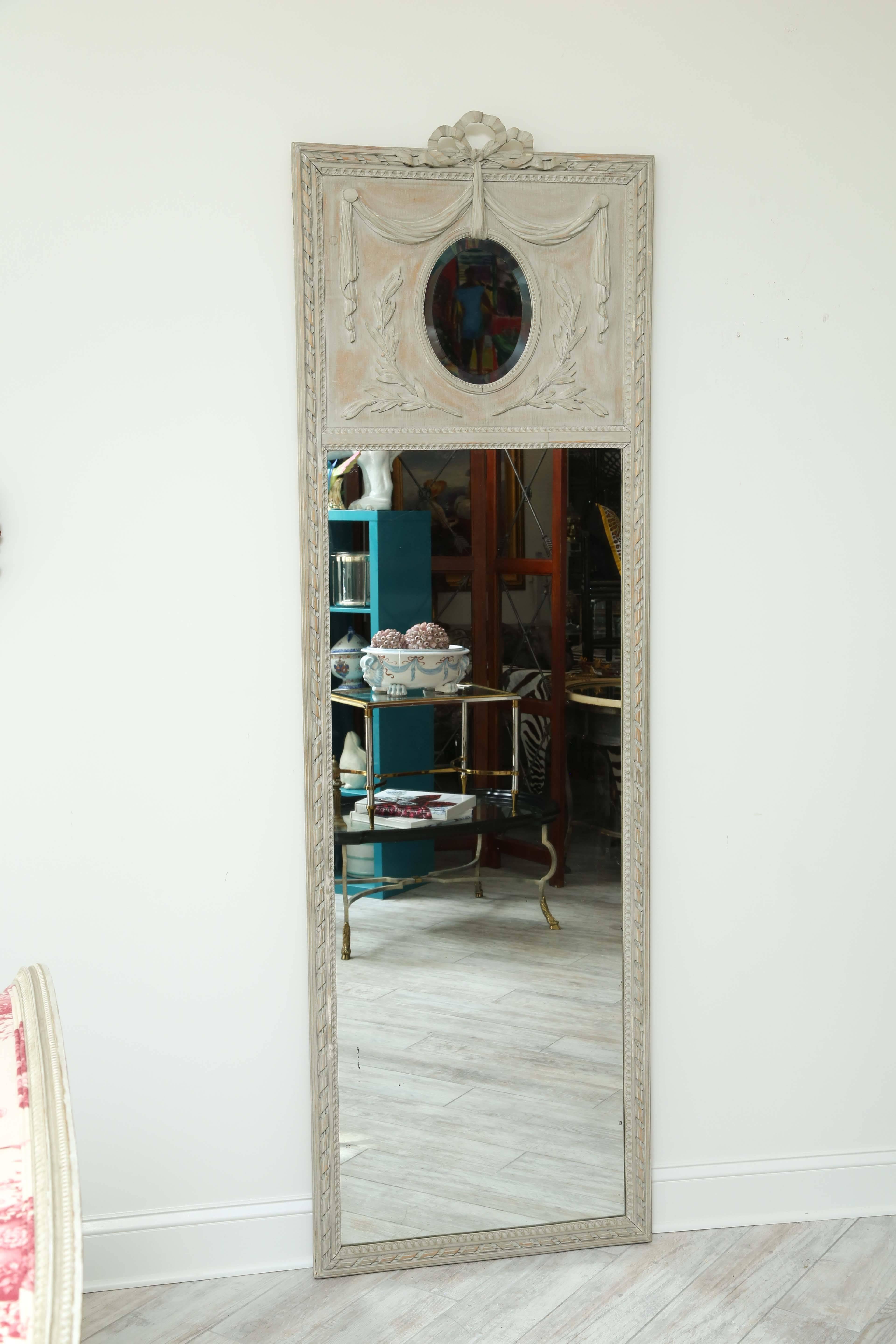 Elegant painted French pier mirror with beautiful wood and gesso details.