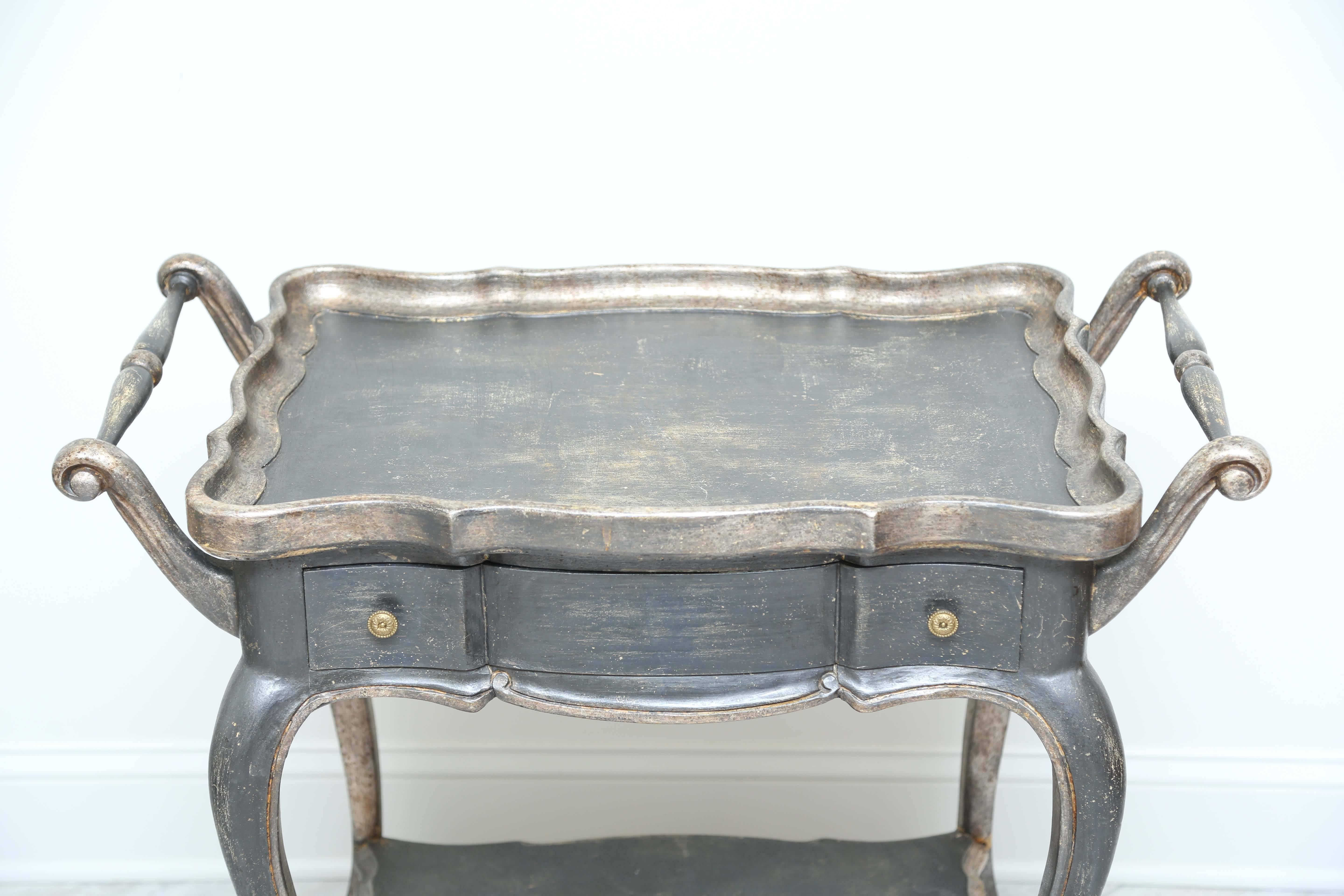 Painted and silver gilded two-tier trolley with one drawer.