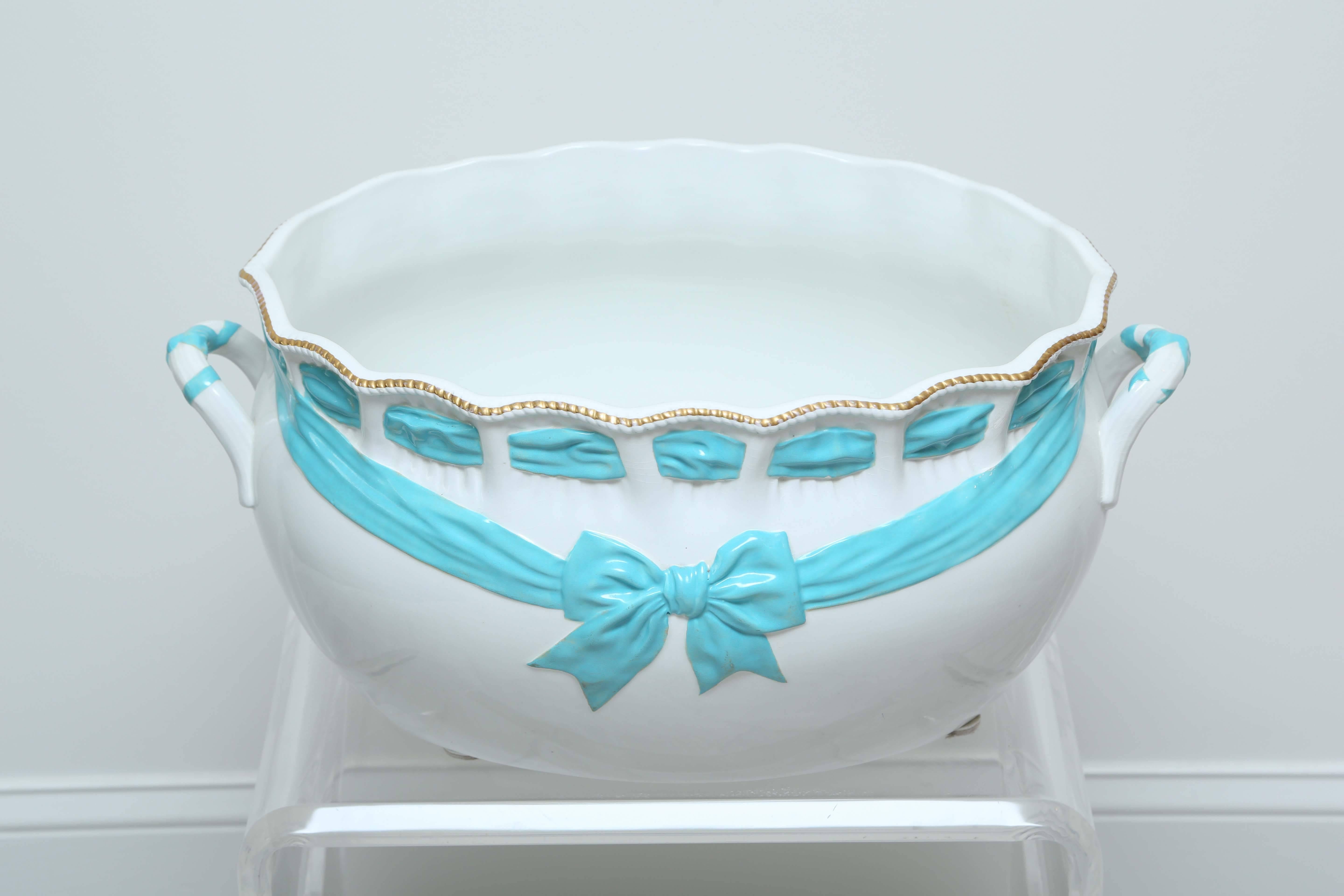 Charming white porcelain footbath decorated with a turquoise ribbon and gold beads.