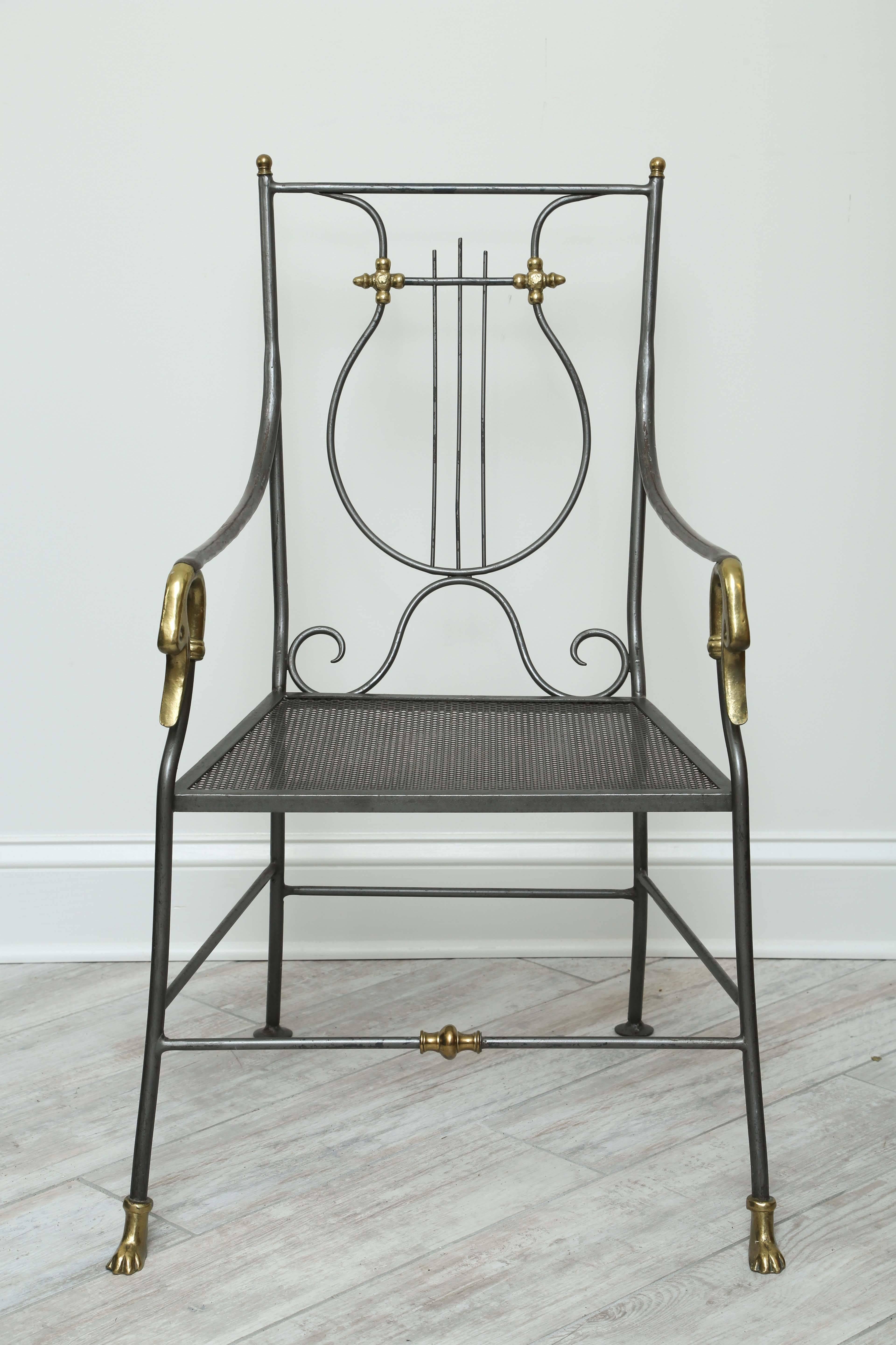 Charming steel and brass armchair with lyre back, swan arms and webbed feet.