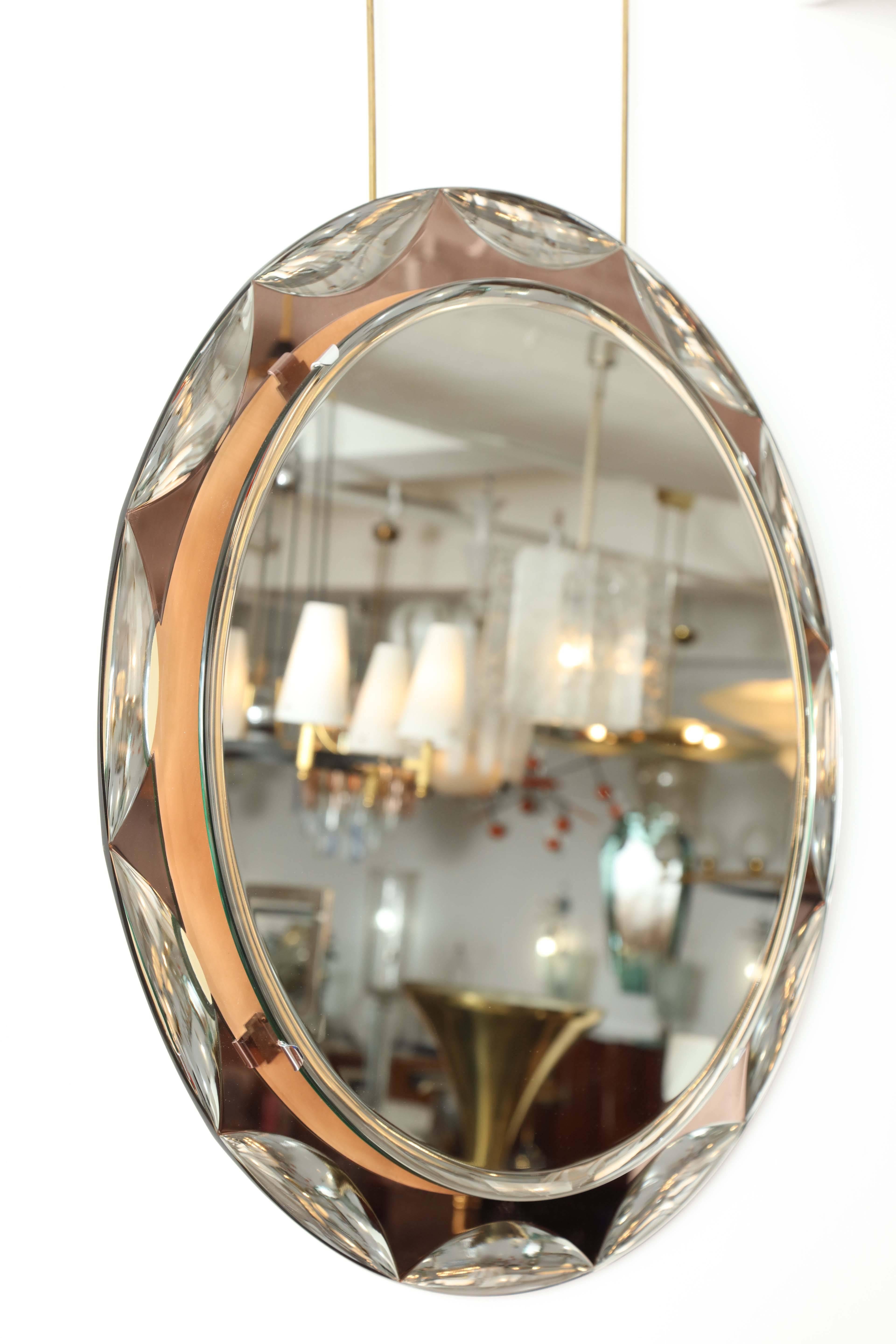 Stunning round beveled scalloped mirror with salmon colored glass frame made in Italy, 1955 by Crystal Arte, unusual beautiful quality.