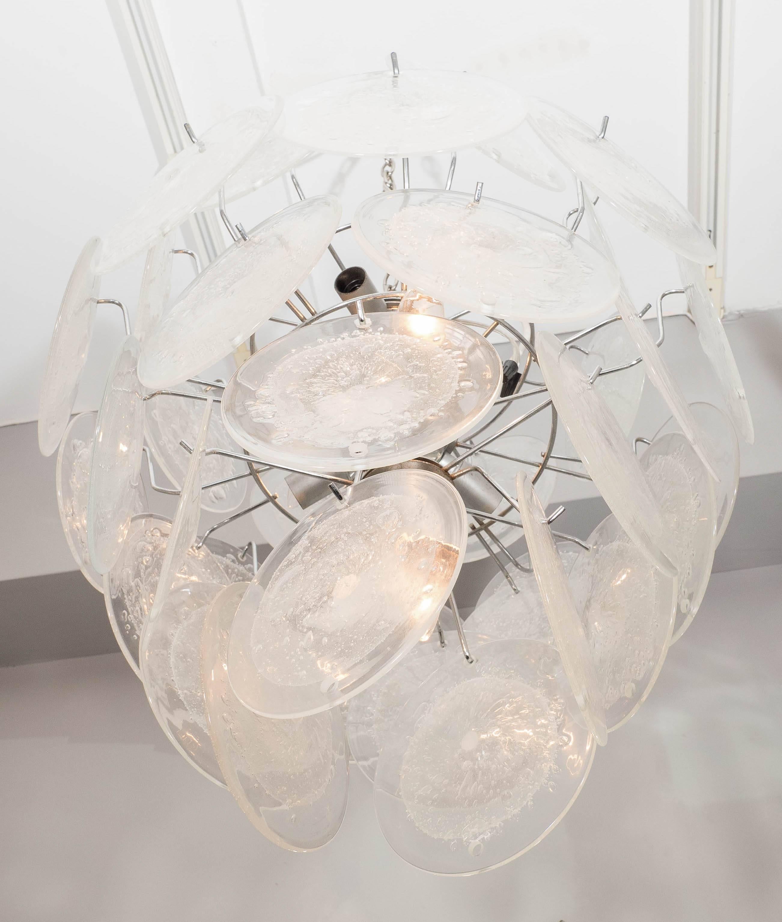 Clear Pulegoso Murano glass disc chandelier. Customization is available in different sizes, finishes and glass colors.