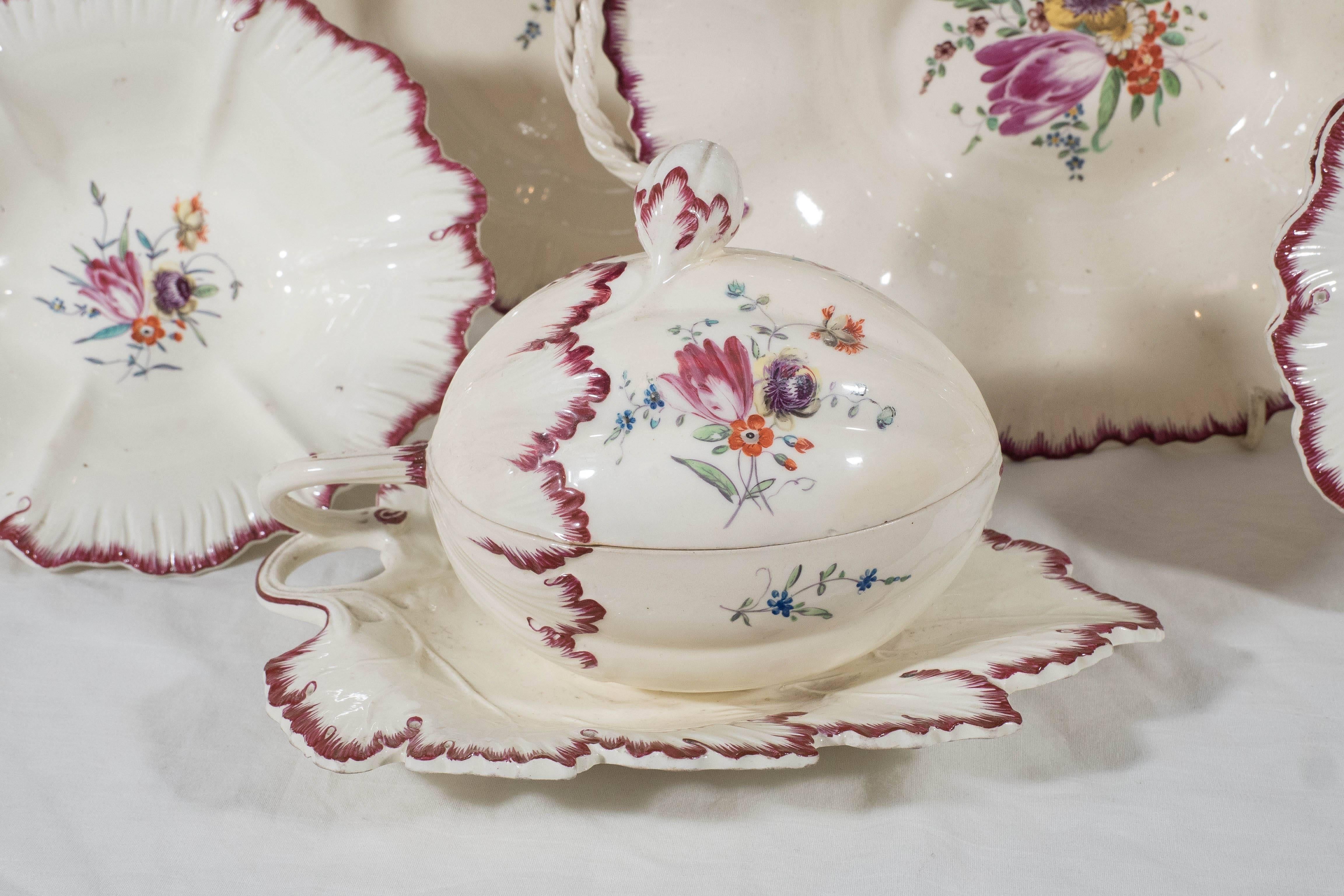 An extensive 18th century creamware dessert set hand-painted with sprays of colorful flowers. Decorated with a beautiful claret colored shell edge rim. Made in England by Neale and Co., circa 1780. It is rare to find a large 18th century creamware