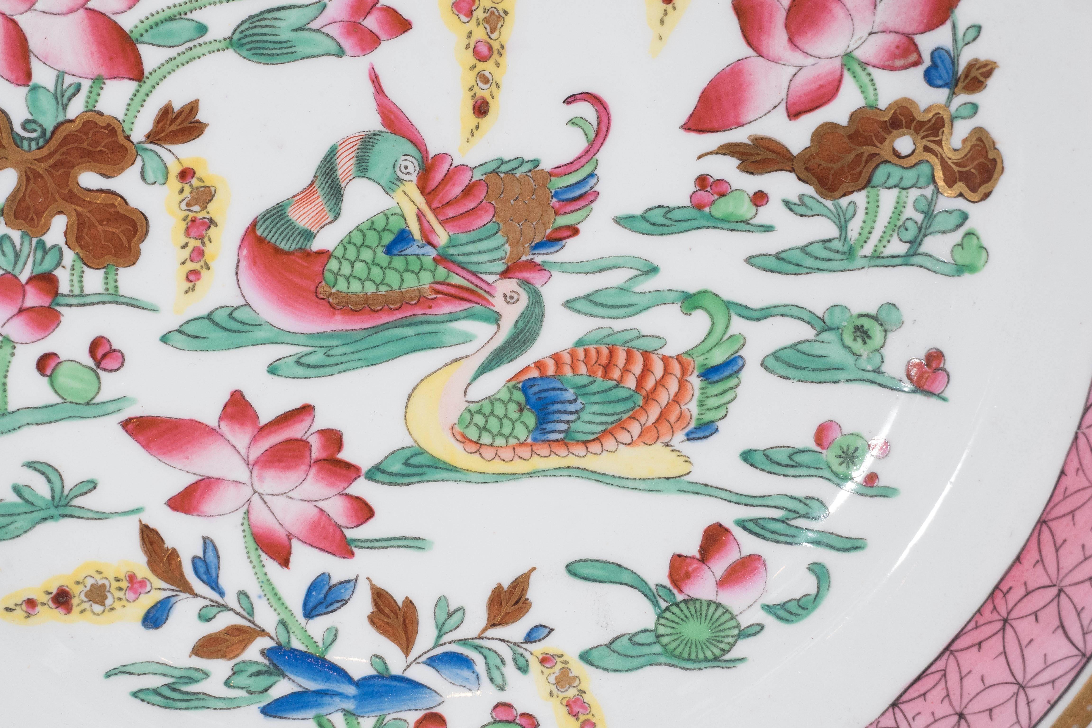 We are pleased to offer this fine set of 16 Spode antique porcelain dishes in the Mandarin Ducks pattern painted with lively Famille Rose colors showing a chinoiserie scene with a pair of Mandarin ducks swimming near pink water lilies. In Chinese