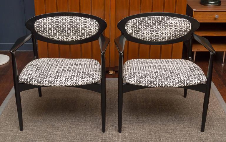 Pair of stylish Danish fruitwood armchairs that have been lacquered black and newly upholstered.