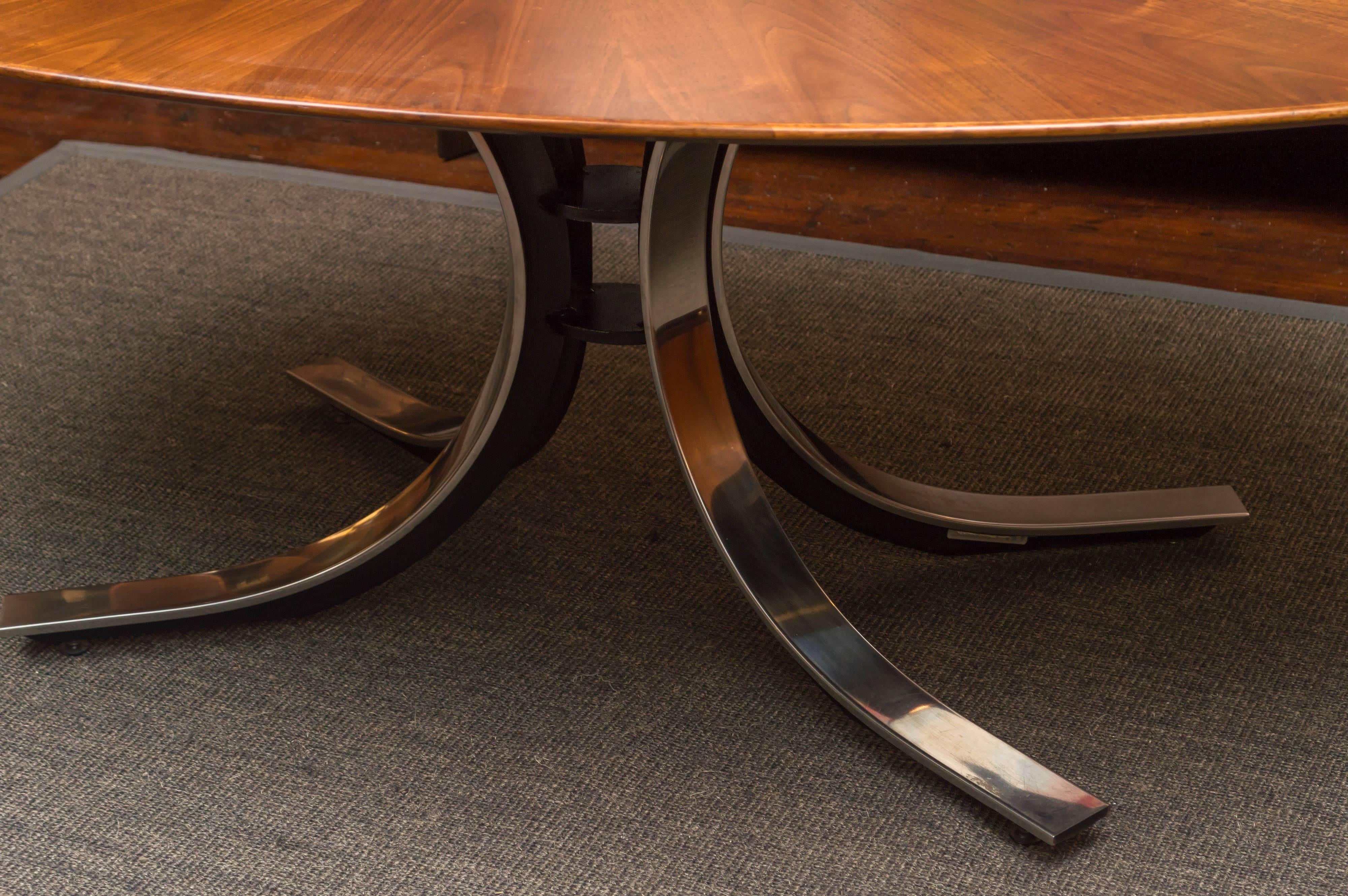 Beautiful design oval dining table on a chrome pedestal base in the style of Osvaldo Borsani. Top is a starburst walnut veneer pattern, perfectly refinished.