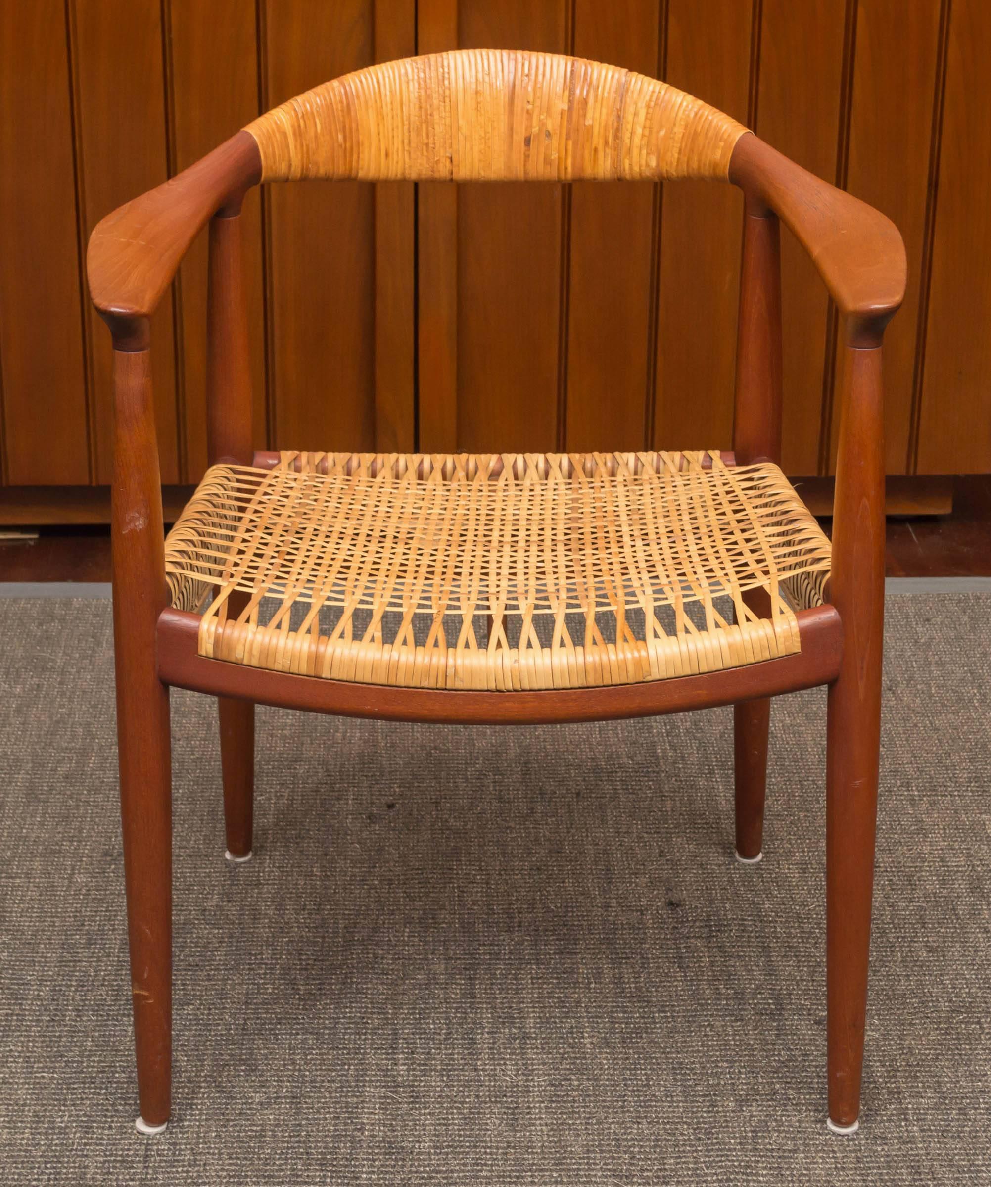 Elegant and refined teak and caned armchair by Hans Wegner for Johannes Hansen, Denmark. Excellent original condition.