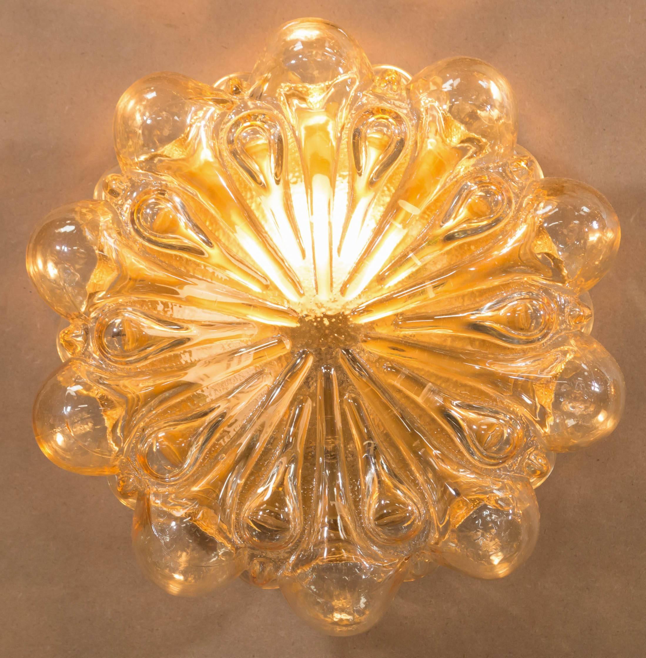 Stunning Mid-Century vintage German made bubble glass sconce that can also be used as a flush mount ceiling fixture; designed by Helena Tynell for Glashütte Limburg in the early 1960s. Featuring beautiful amber/champagne colored glass it will warm