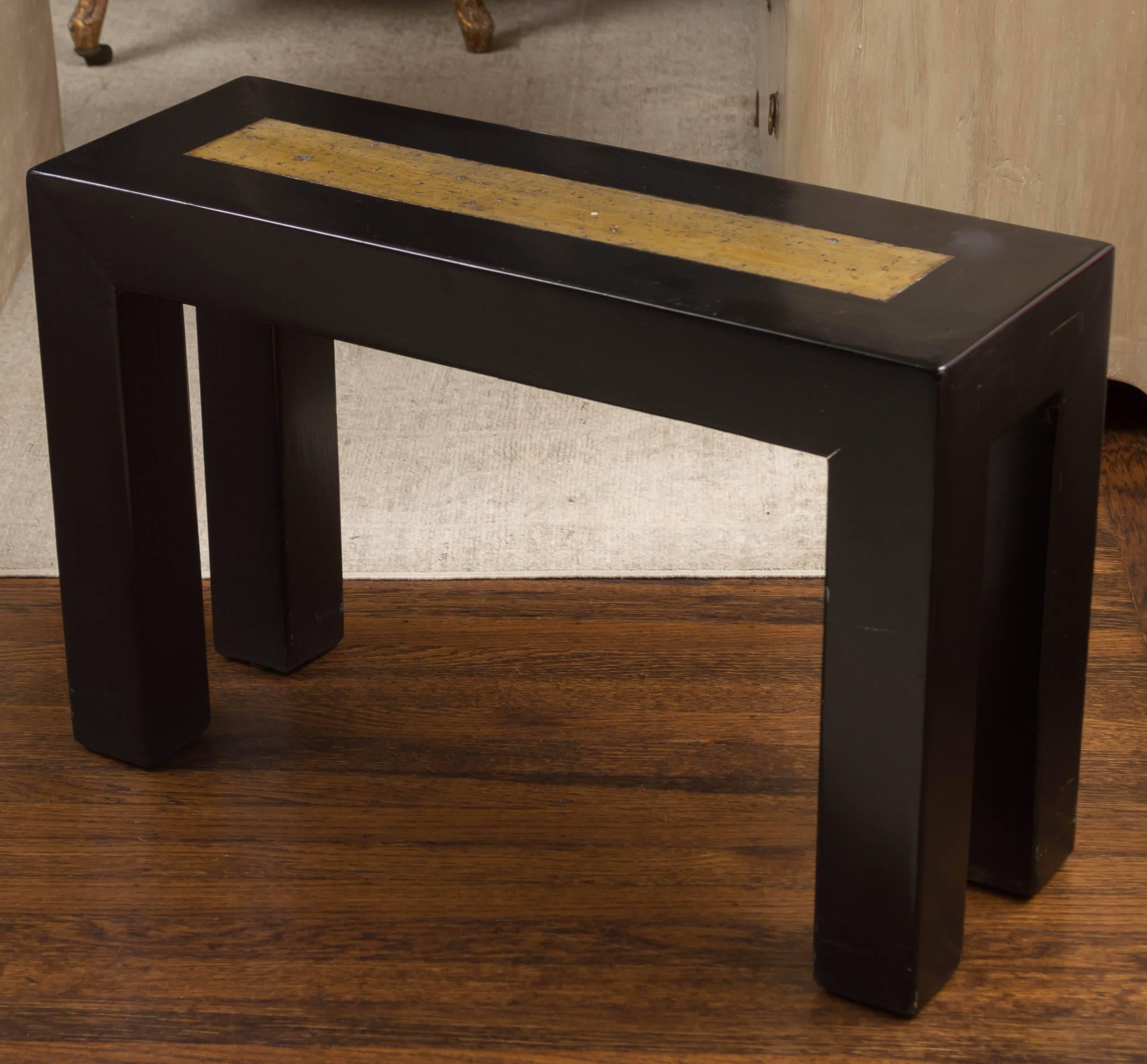 The rectangular top with inlaid citrine-colored marble set into a mortise and tenoned frame, raised on square section legs. May be used as a table or bench for seating. The category is table.