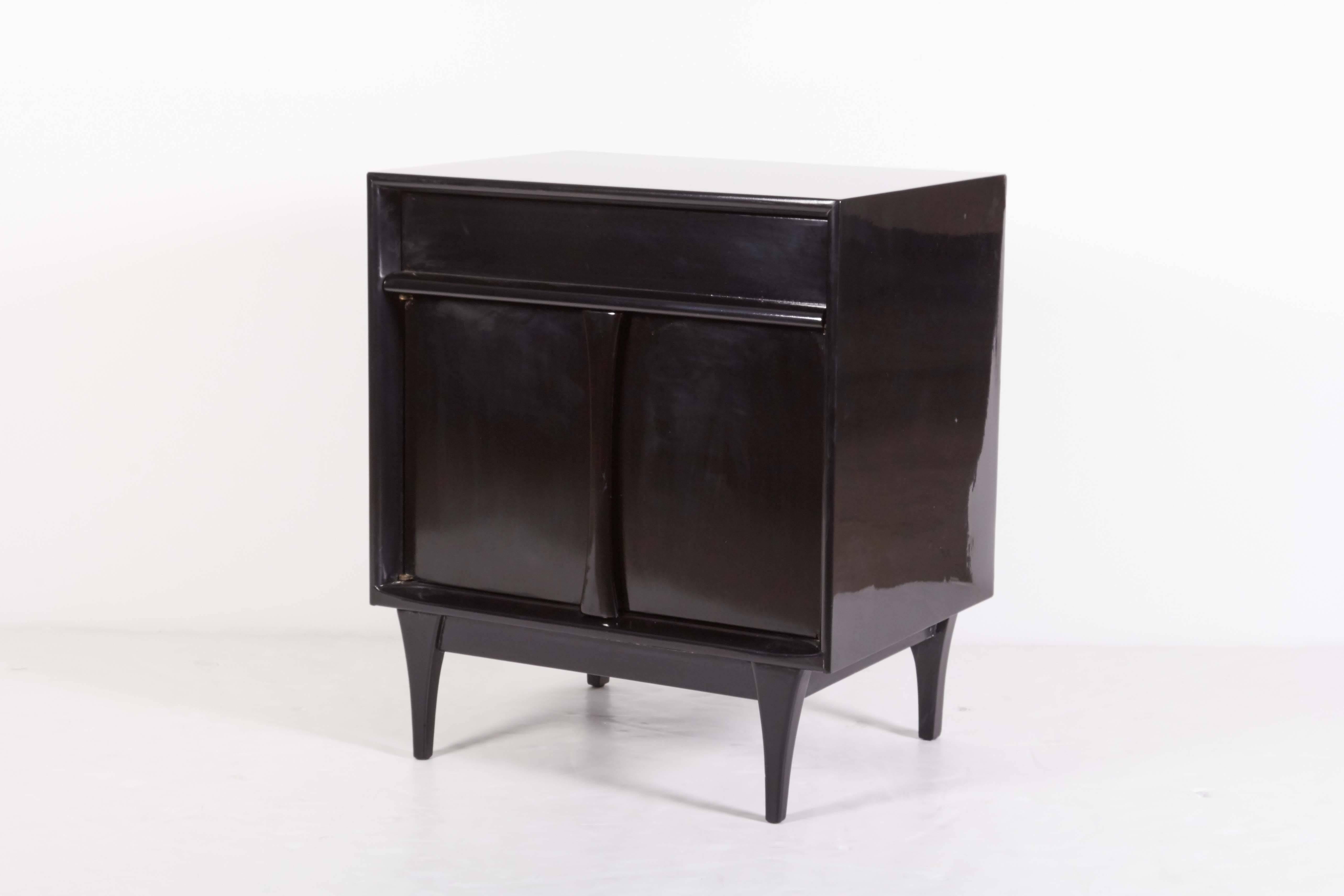 Pair of Mid-Century ebonized night tables, two doors, one drawer, round tapered legs, later ebonzied.
