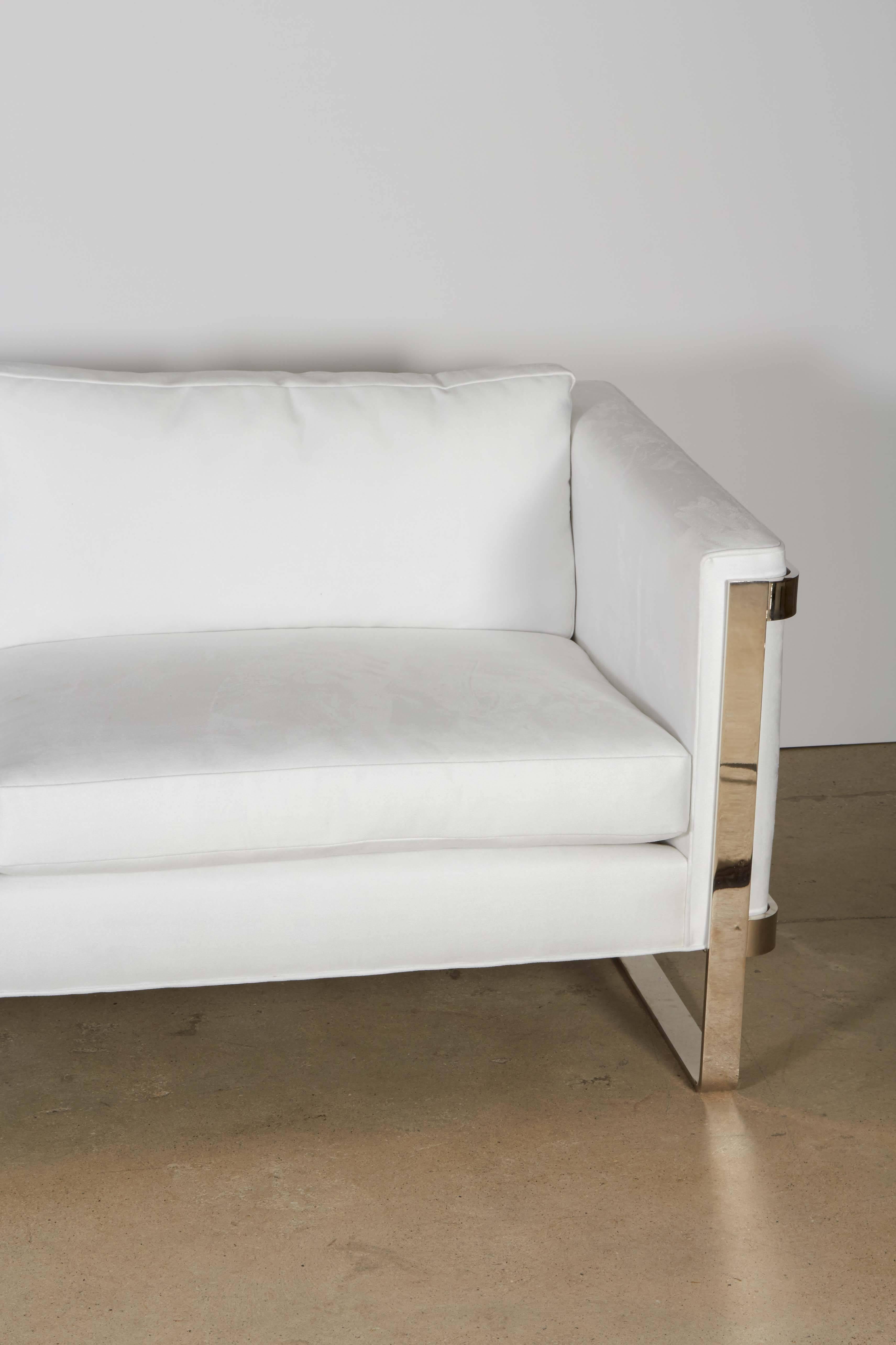 The sofa has been recovered in a heavy duty, high quality ultra suede fabric. Its pure white but easy to clean. The steel encasement has been nickel-plated.