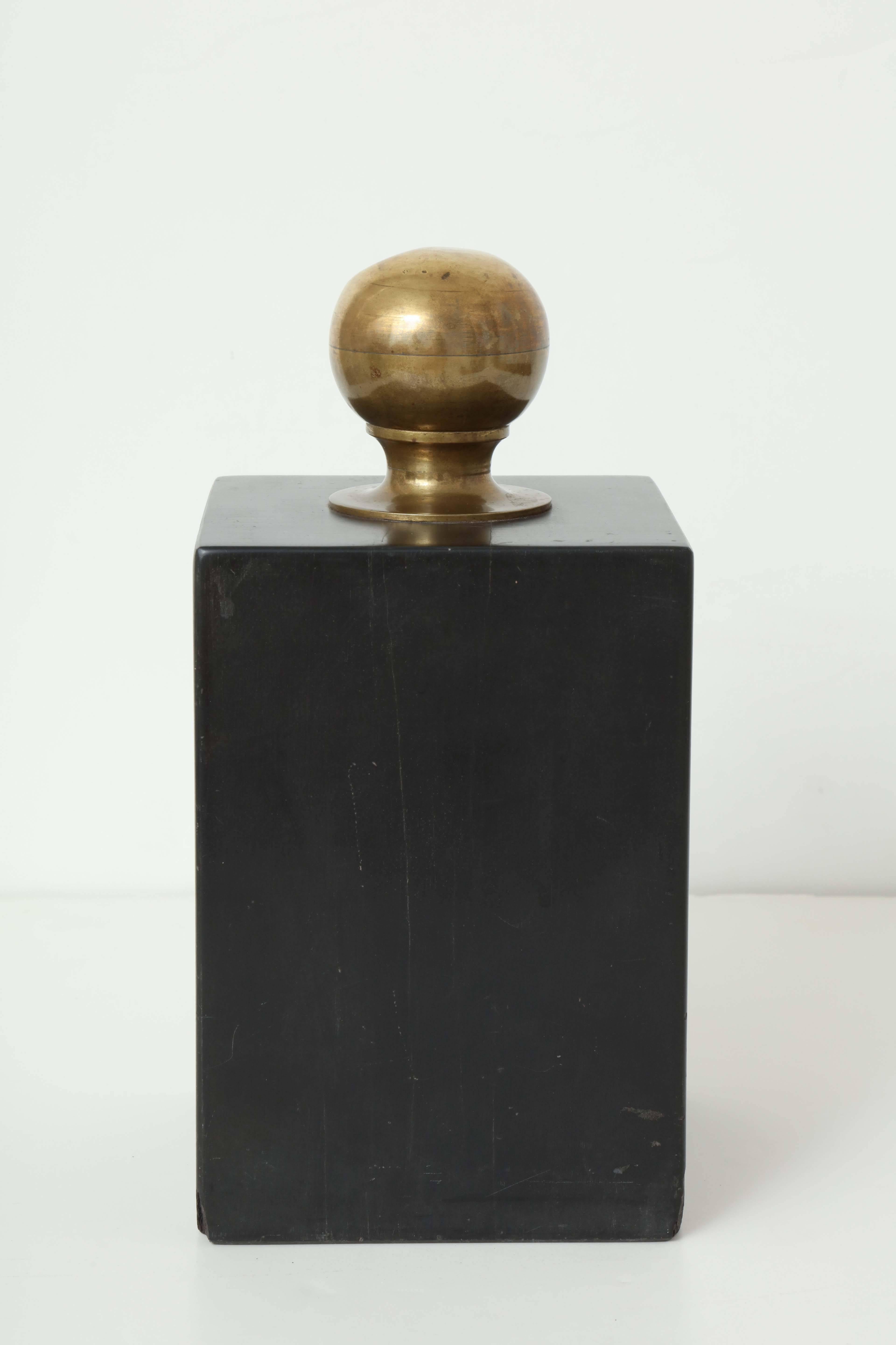 A late 19th century English rectangular slate doorstop with round brass finial.