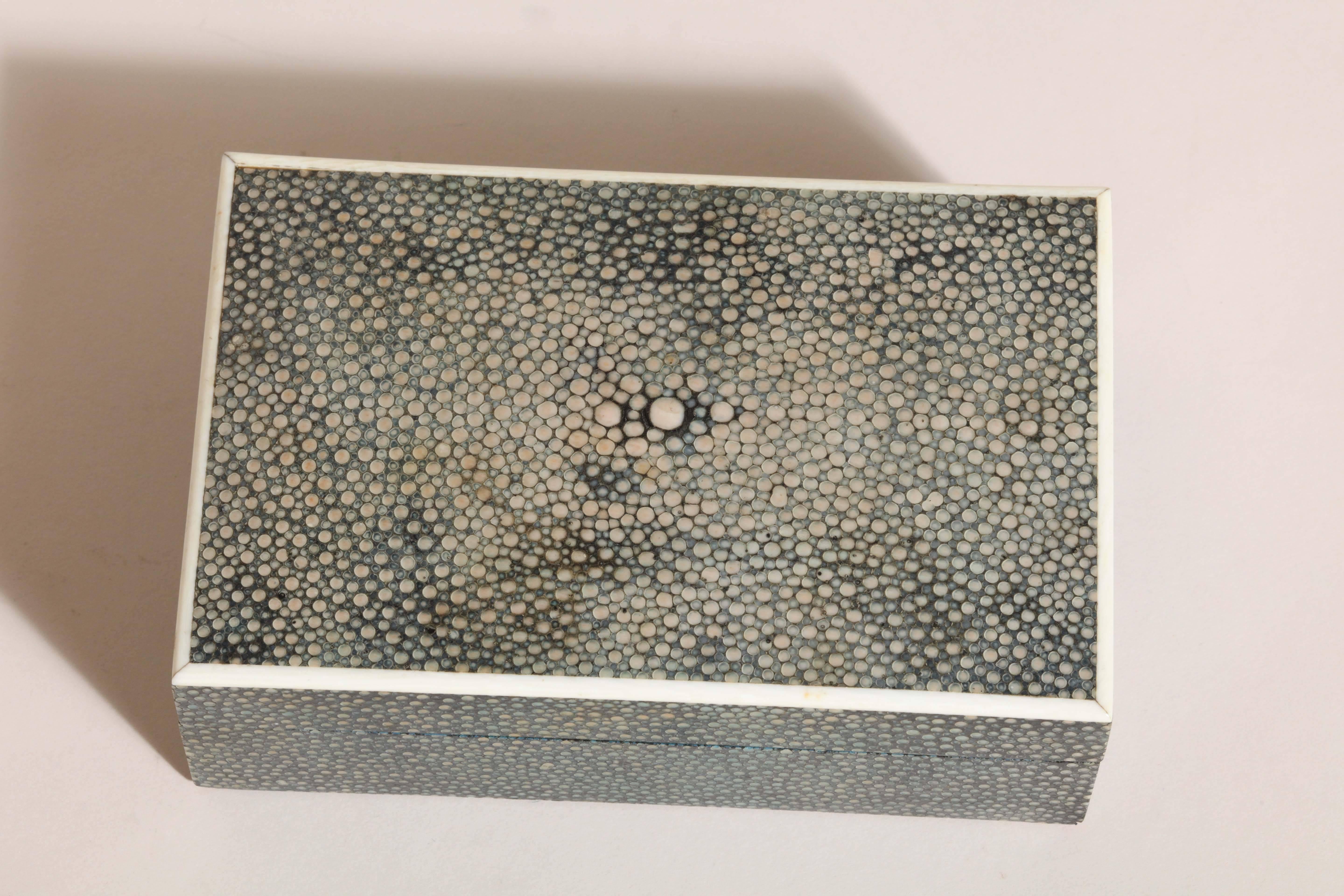 Polished green shagreen box with bone banding around the top.

Stamped ASPREY/ LONDON MADE on leather underneath and impressed LONDON MADE on hinge.
