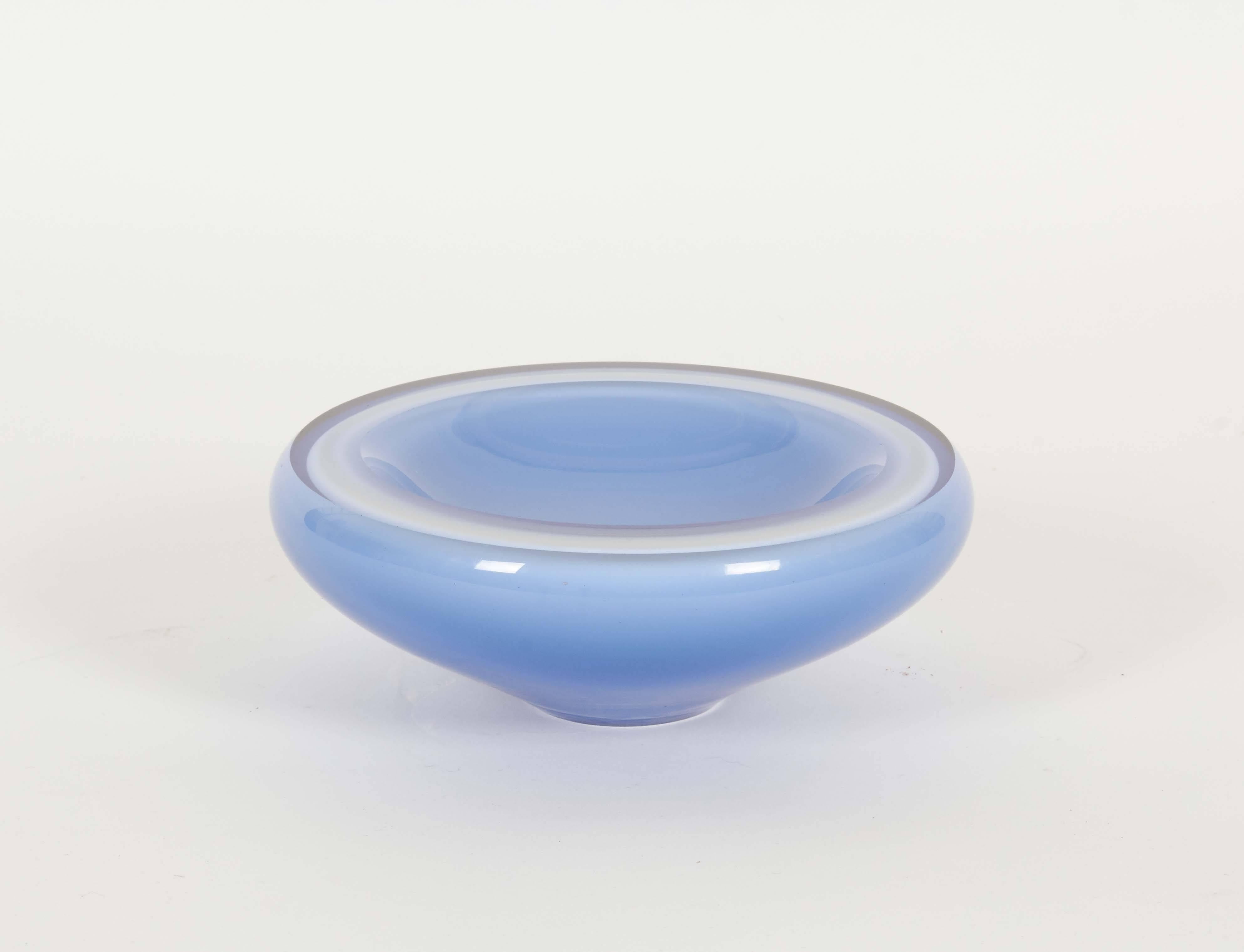 A vintage decorative art glass bowl, with light blue layer surrounding a cased white interior. Despite minuscule wear to base, the bowl remains in very good condition.