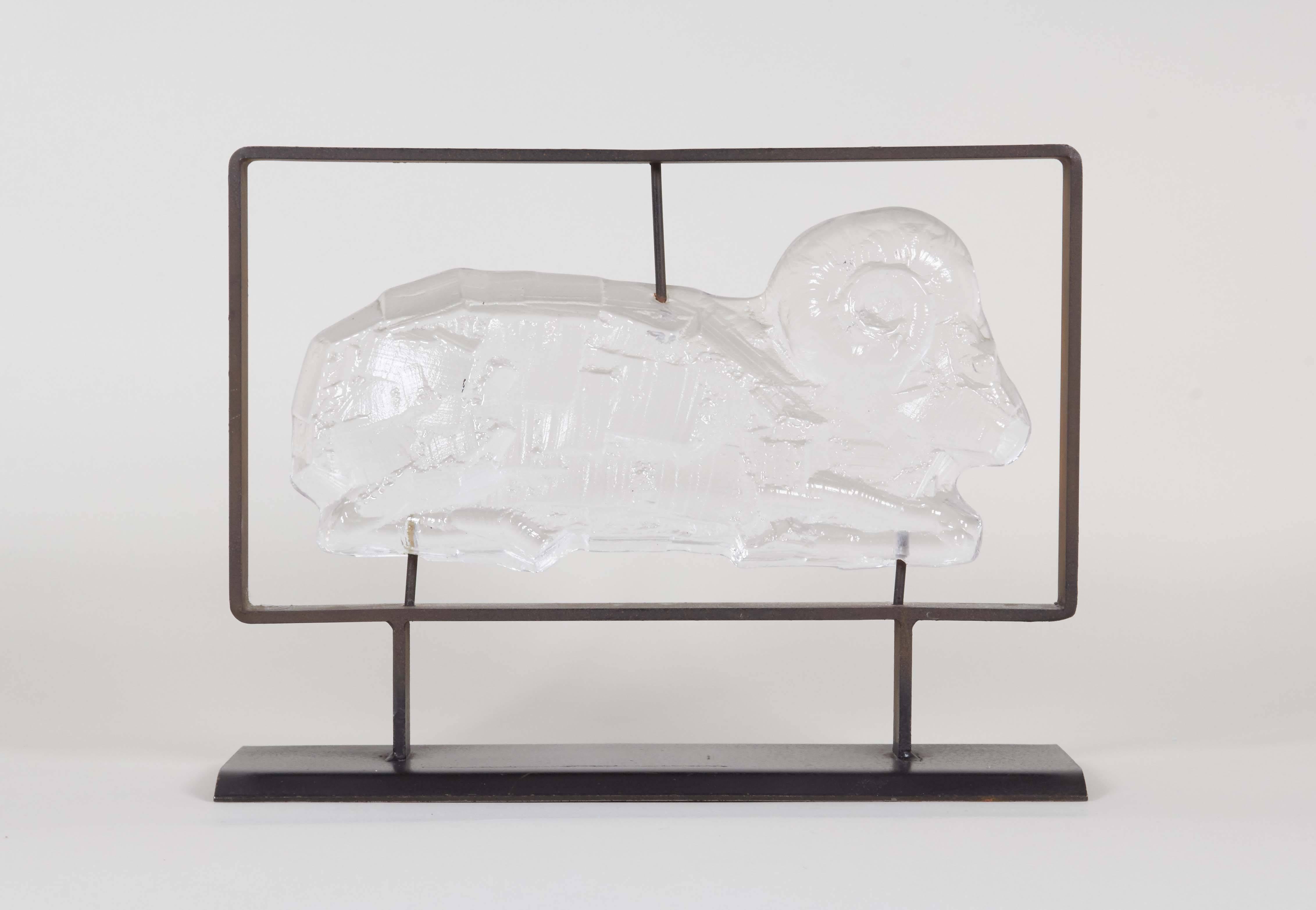 A sculptural ram by Erik Höglund for Kosta Boda, produced in Sweden, circa 1950s-1960s, crafted of clear, artfully detailed glass, mounted on a metal stand. Very good vintage condition, wear to base consistent with age and use.
