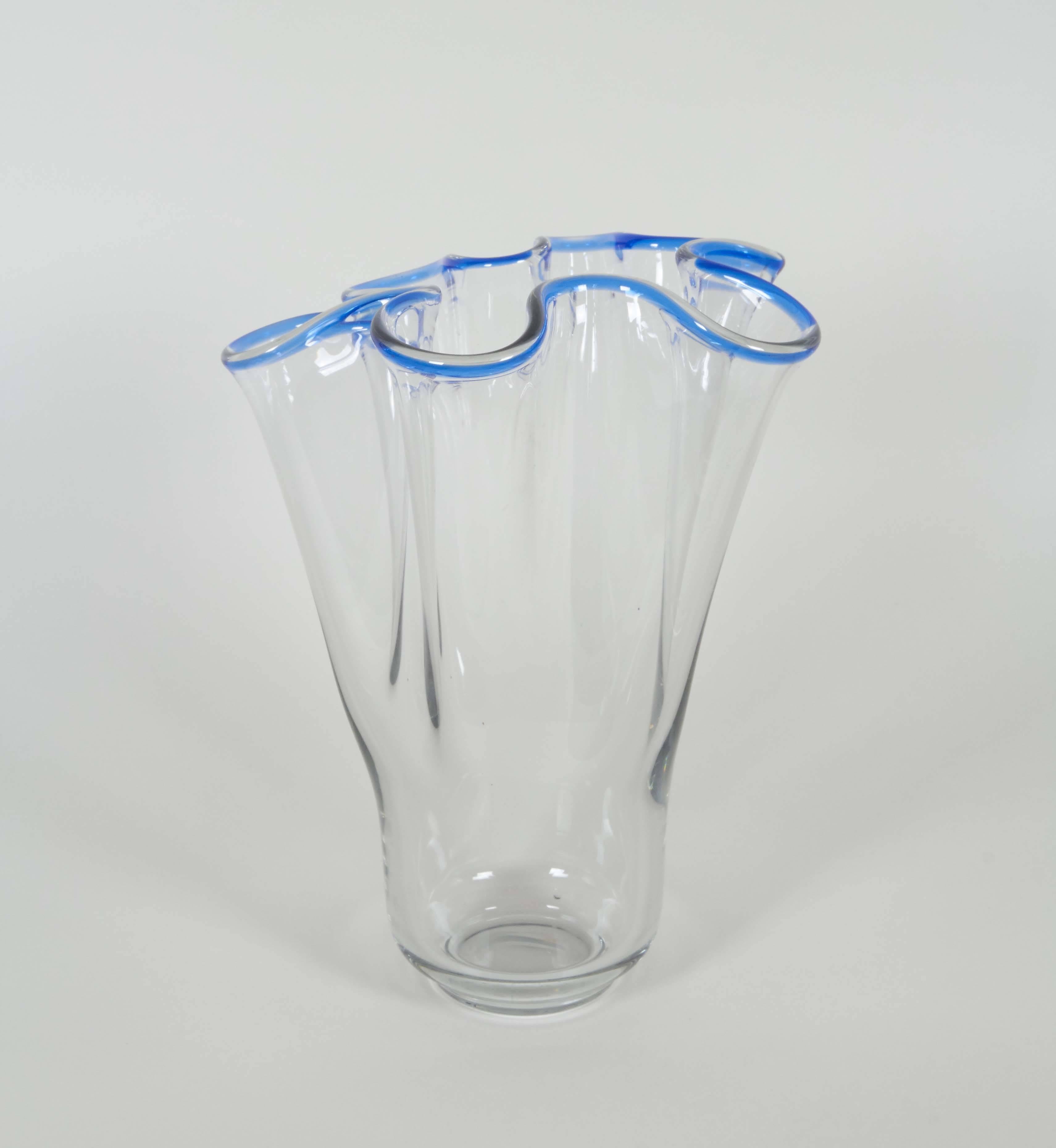 A vintage art glass footed vase, in clear glass with flared 'handkerchief' style blue rim. This vase remains in very good condition, minuscule wear to base consistent with age and use.

10439