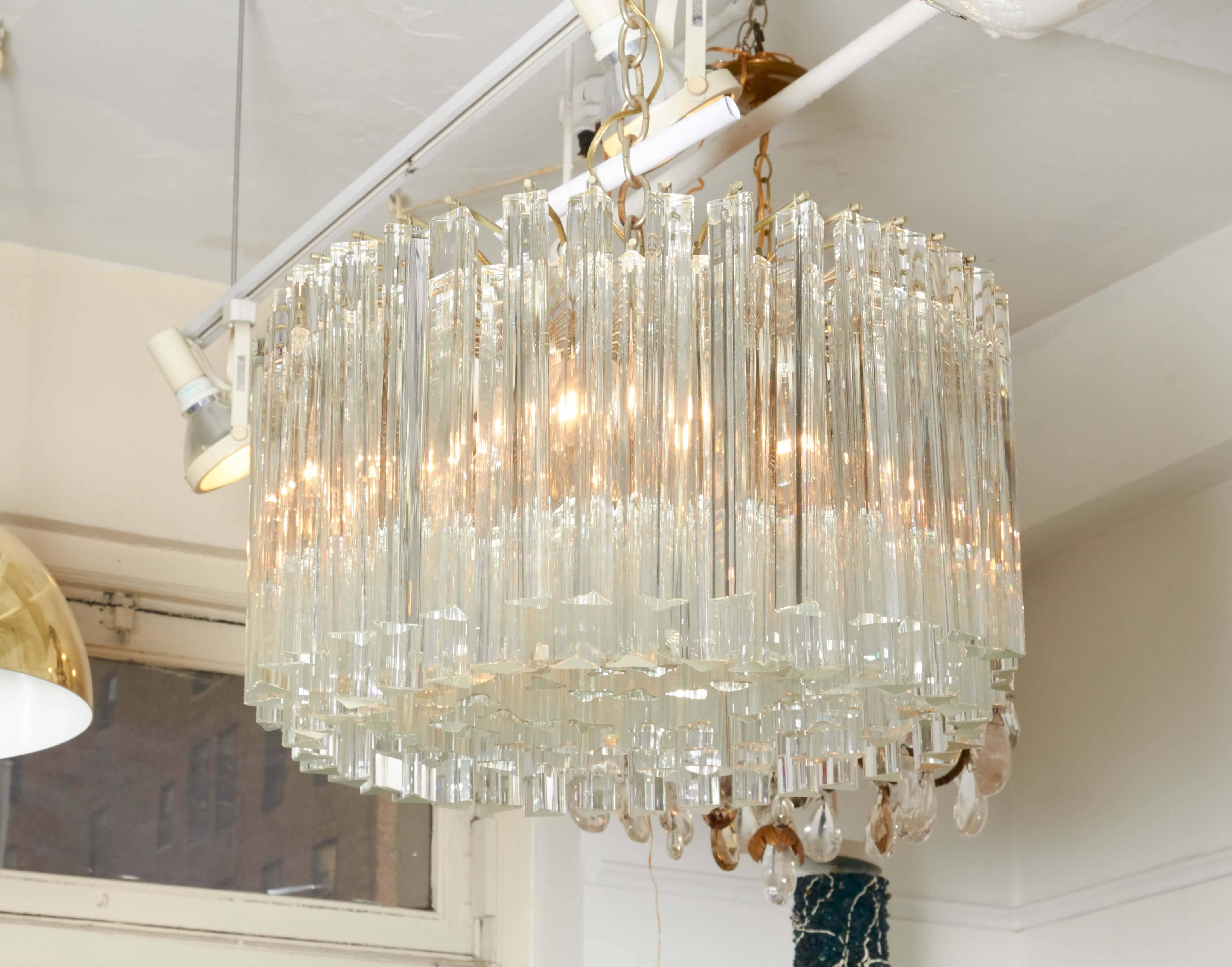 A Camer Glass chandelier, manufactured in Italy with Murano glass triedri prisms by Venini, circa 1960s. Requires six bulbs. Markings include original label [camer glass/ made in Italy]. This light fixture remains in excellent vintage condition,