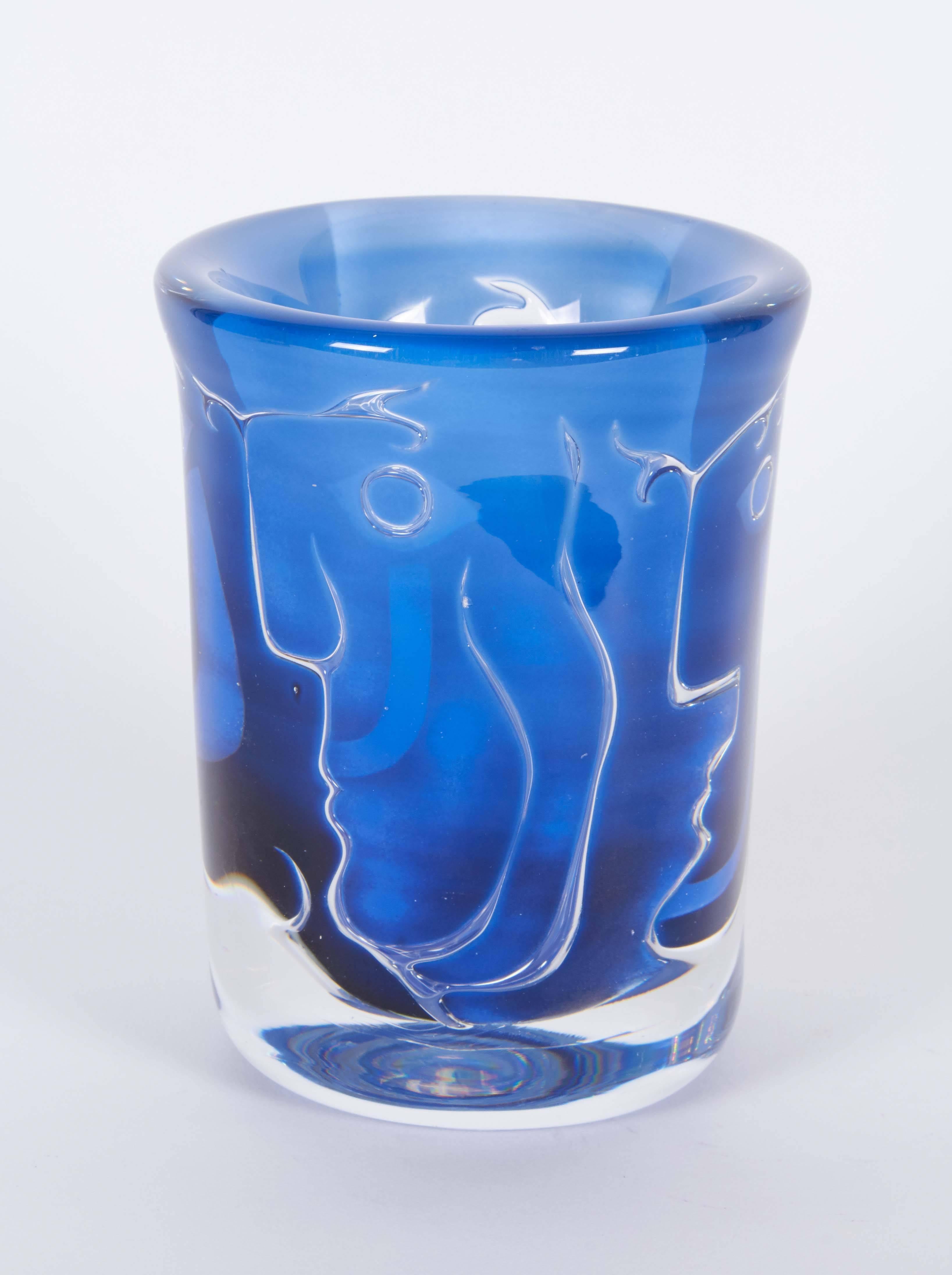 An Orrefors 'Ariel' vase by Ingeborg Lundin, produced circa 1960s, in cobalt blue, cased within a clear layer, detailing abstract faces in profile. Markings include [Orrefors/ Ariel No. 397 - E7/ Ingeborg Lundin], etched to the bottom. Very good