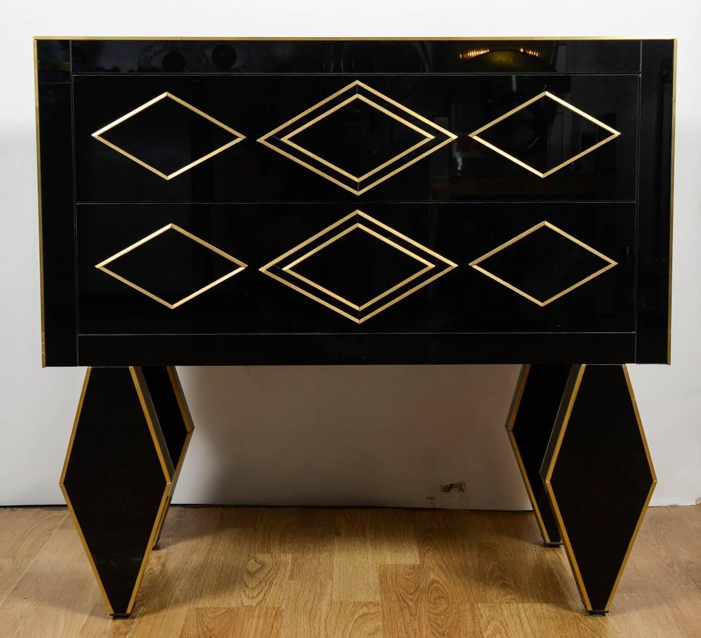 Pair of nightstands in teinted black glass and brass.