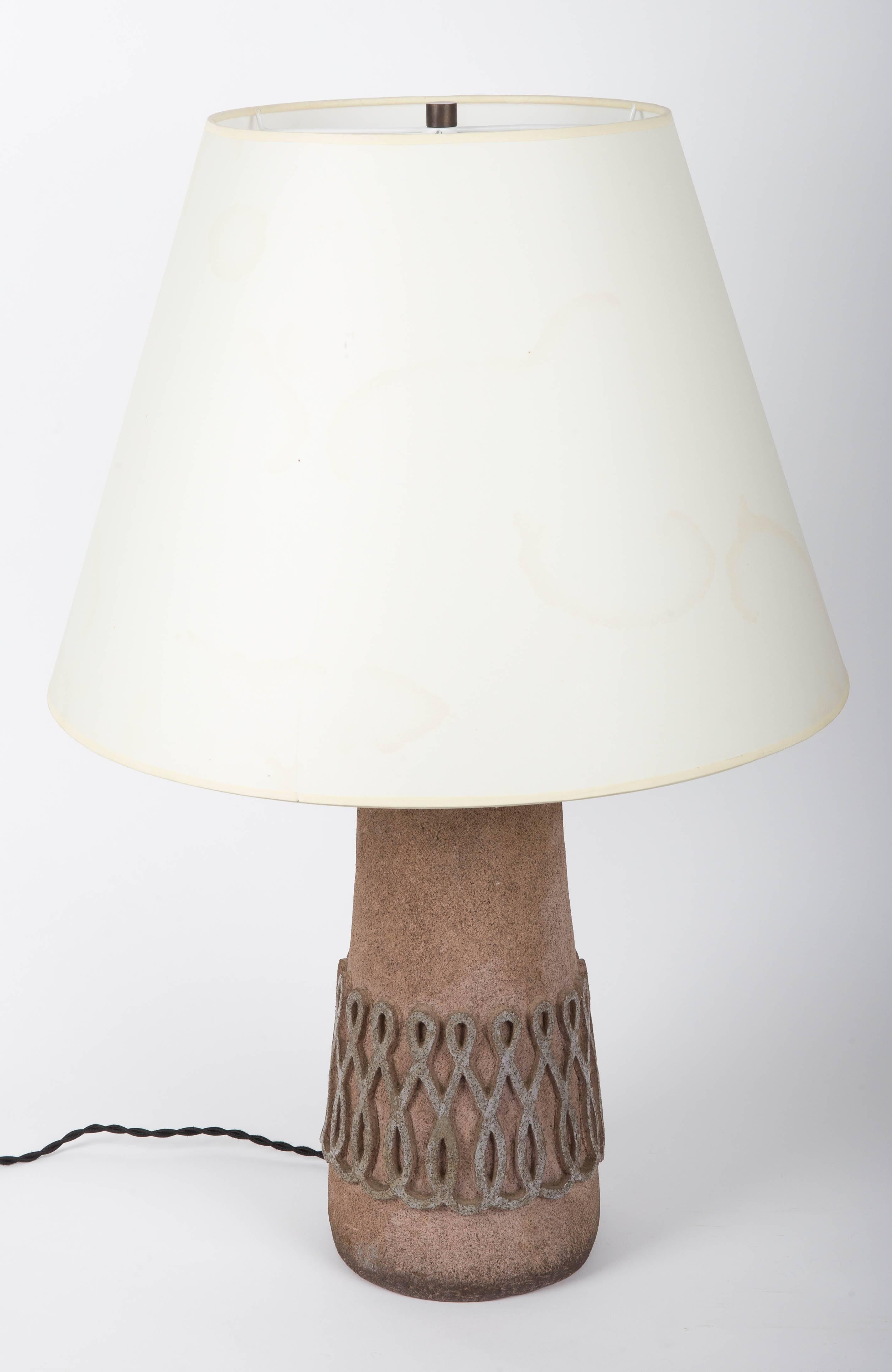 Textured stone table lamp, France, 20th Century. 

Handsome shape, earthen brown textured stone base, and stunning looped design that wraps around the entire base of the lamp. 

This light has been newly rewired and outfitted with a black twist silk