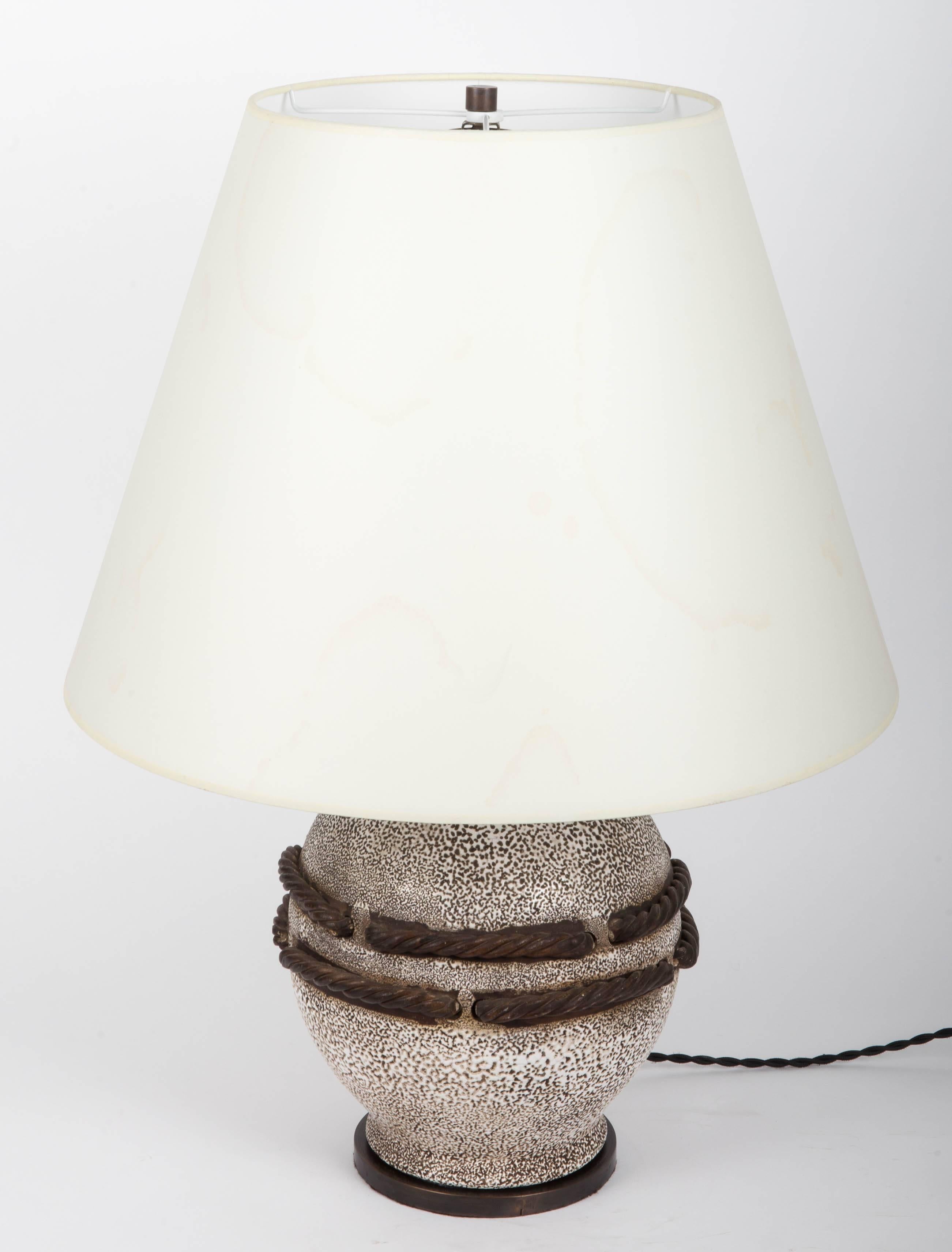 Ivory stone enameled lamp with brown rope detailing, nautical style.