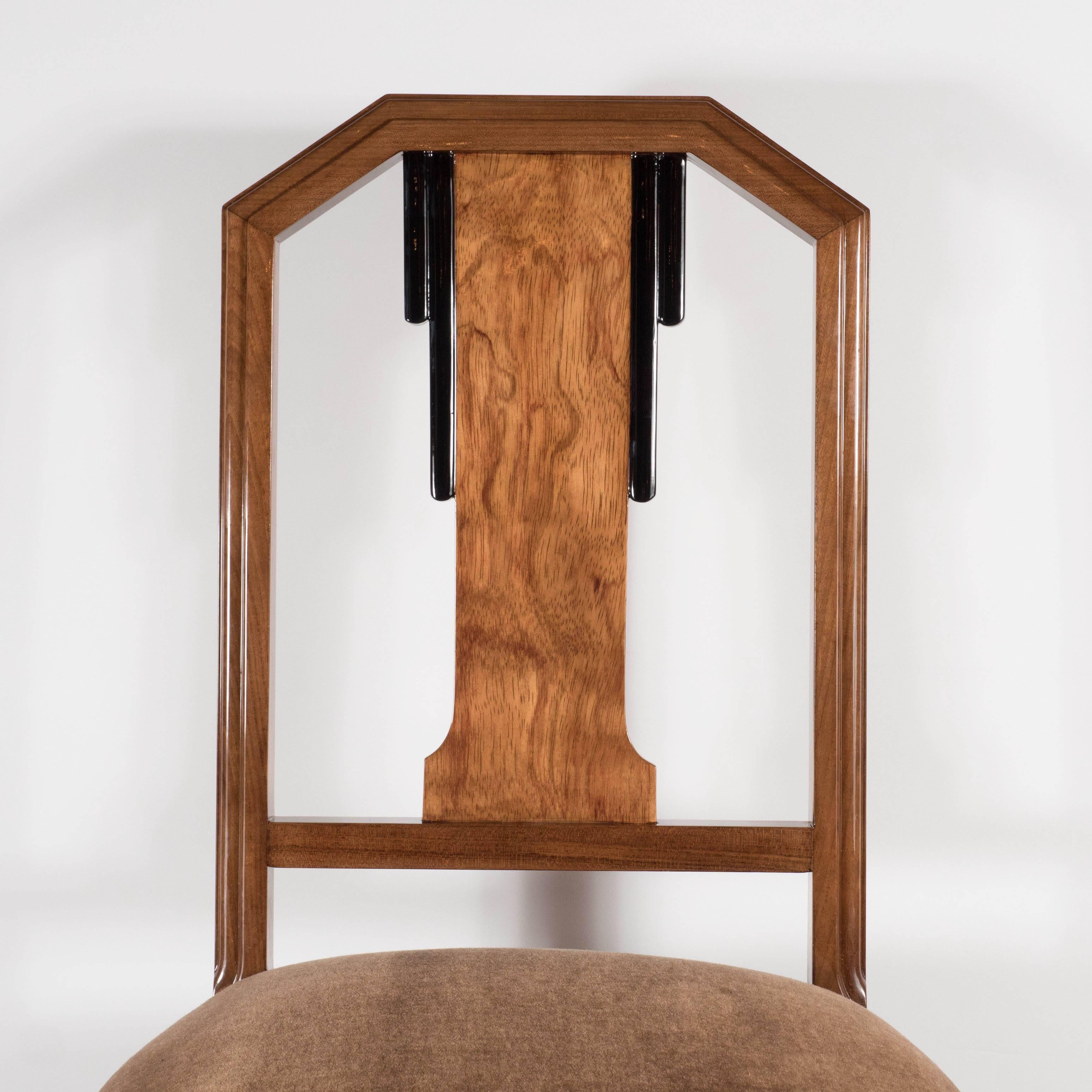 This gorgeous Art Deco skyscraper style two-tone desk or occasional chair was realized in the United States, circa 1935. It features a rectilinear skyscraper style back with a central panel in burled walnut flanked by a stepped black laquer design