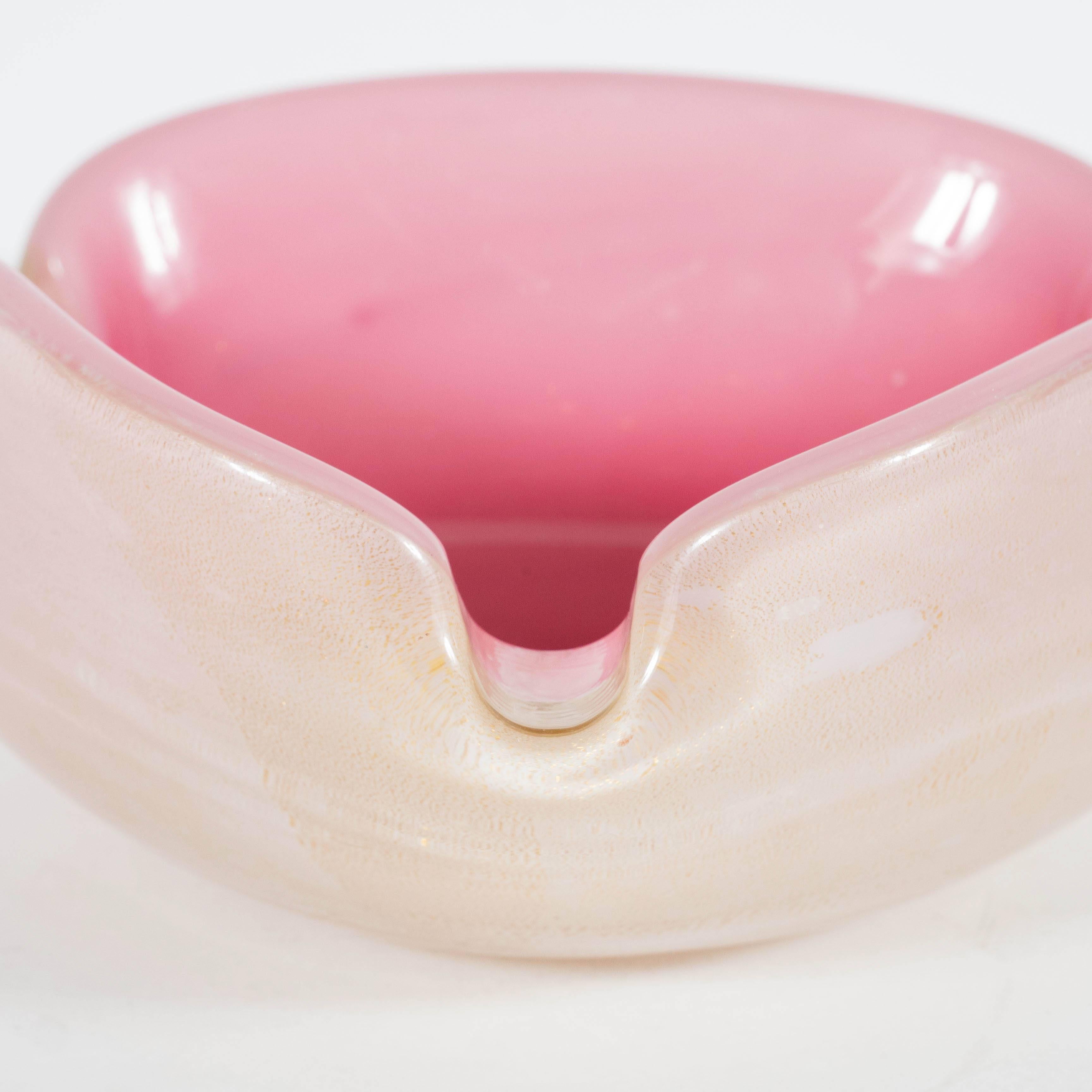 A Mid-Century modernist Bowl featuring a gradient of pink and rose hues with an outer shell adorned in suspended 24-karat gold flecks. A dark magenta center gradually lightens to a soft rose along the outer perimeter. The outside portion of the
