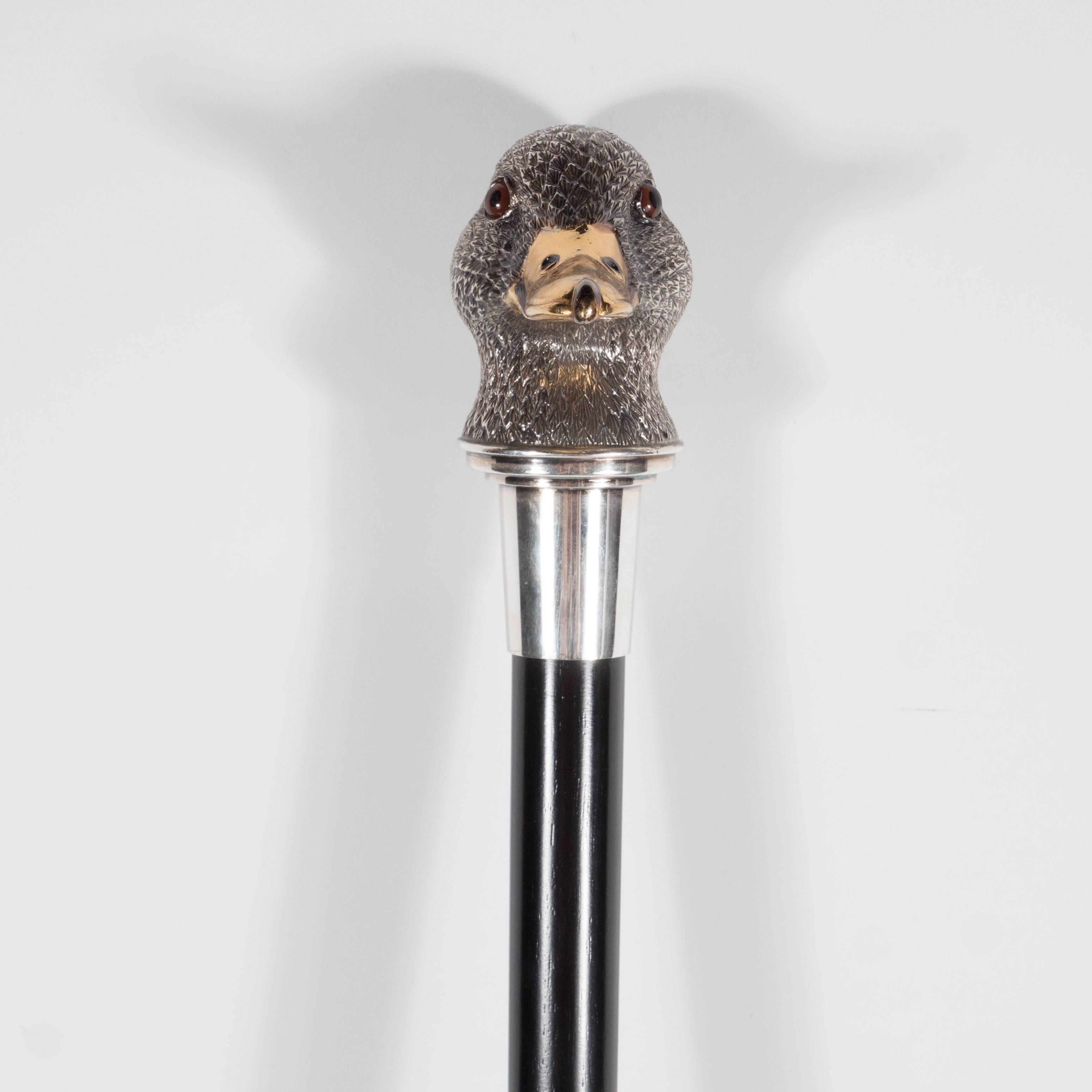Asprey sterling silver duck walking stick ebony wood walking cane with a sterling silver duck head top. Measures: Height 37 1/2 inches. The duck top features a gilt beak with glass eyes and a textured feather like detailing all out of sterling