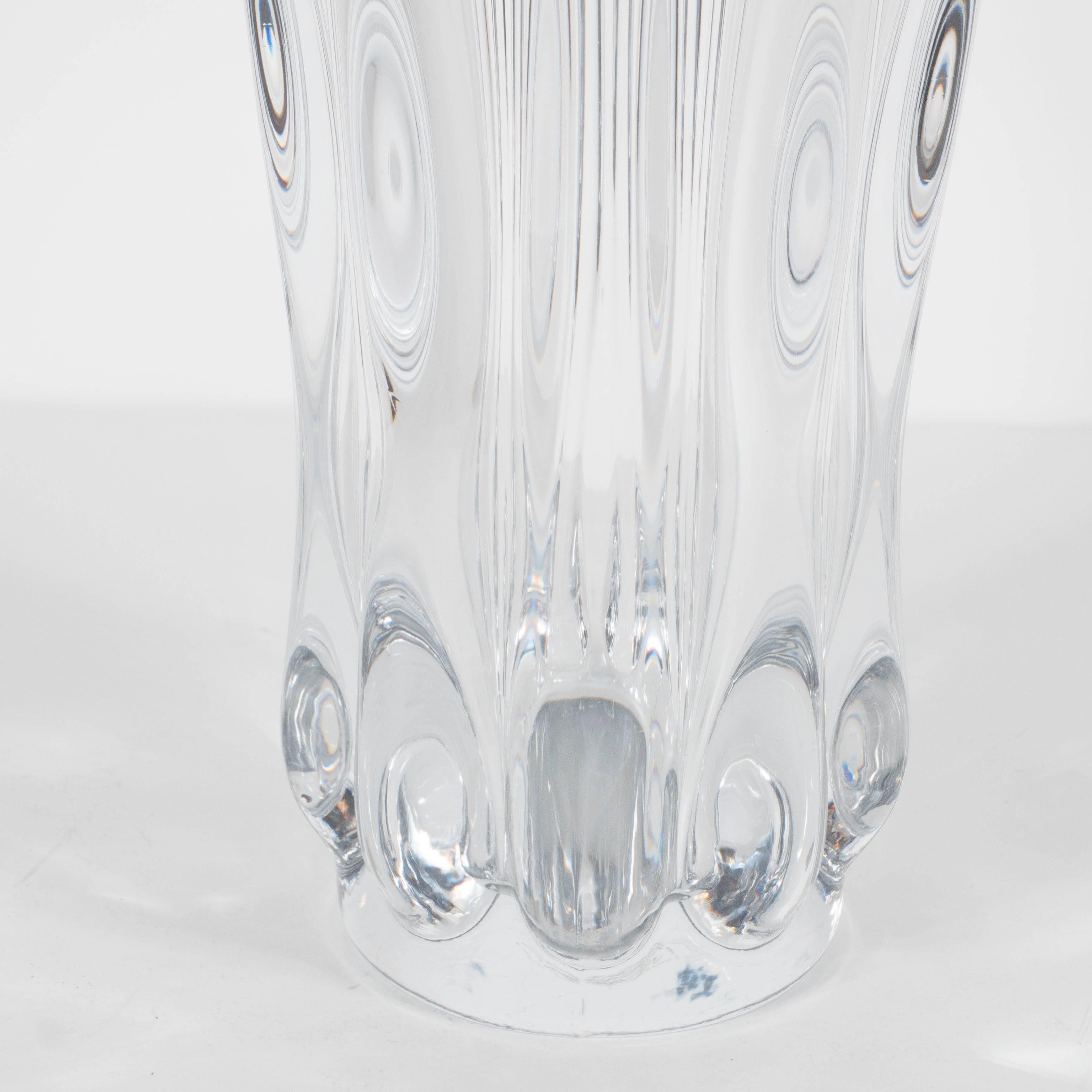This stunning handblown crystal vase features a stylized floriform design. It also has an acid etched factory mark 